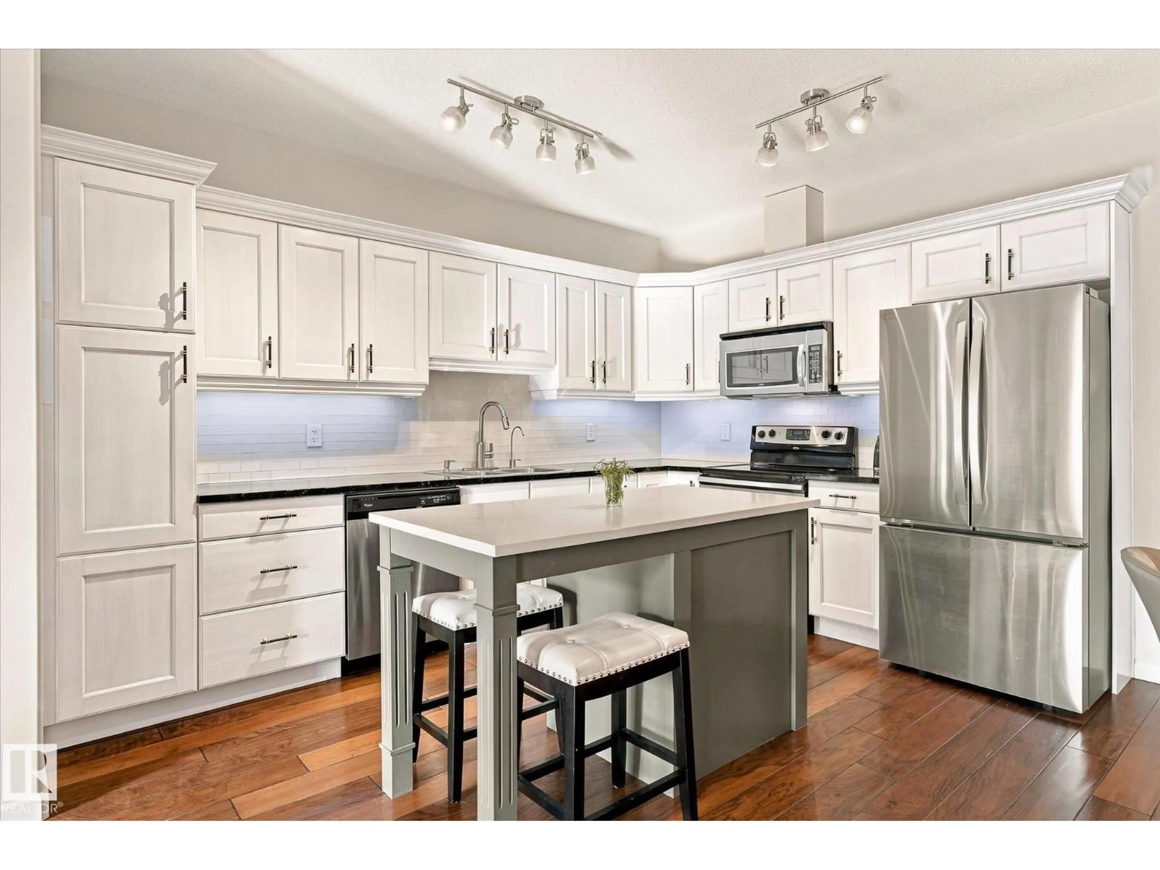 Open concept kitchen, wood/laminate floor for #306 - 6083 MAYNARD WY, Edmonton Alberta T6R0S5