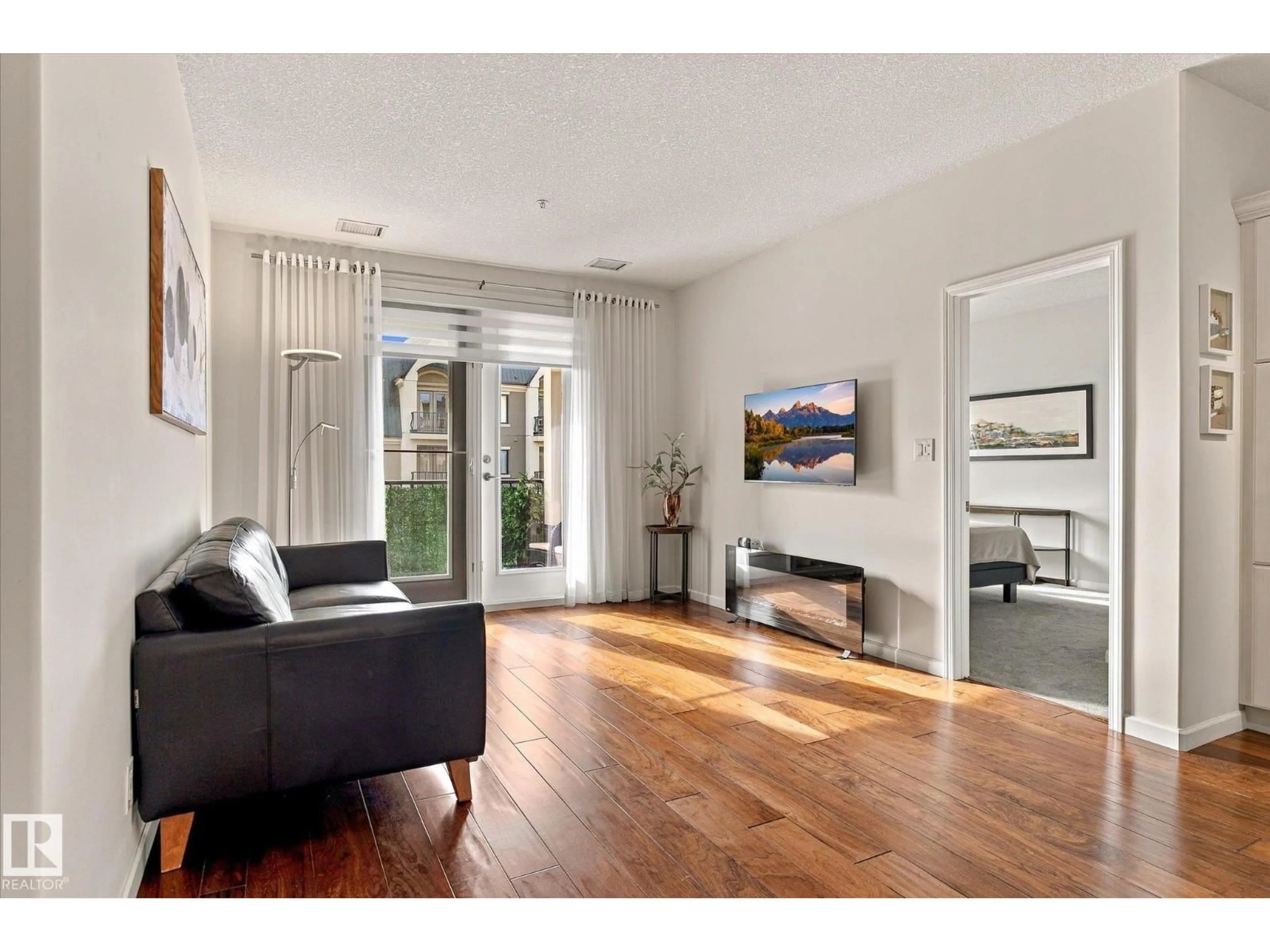 Living room with furniture, unknown for #306 - 6083 MAYNARD WY, Edmonton Alberta T6R0S5