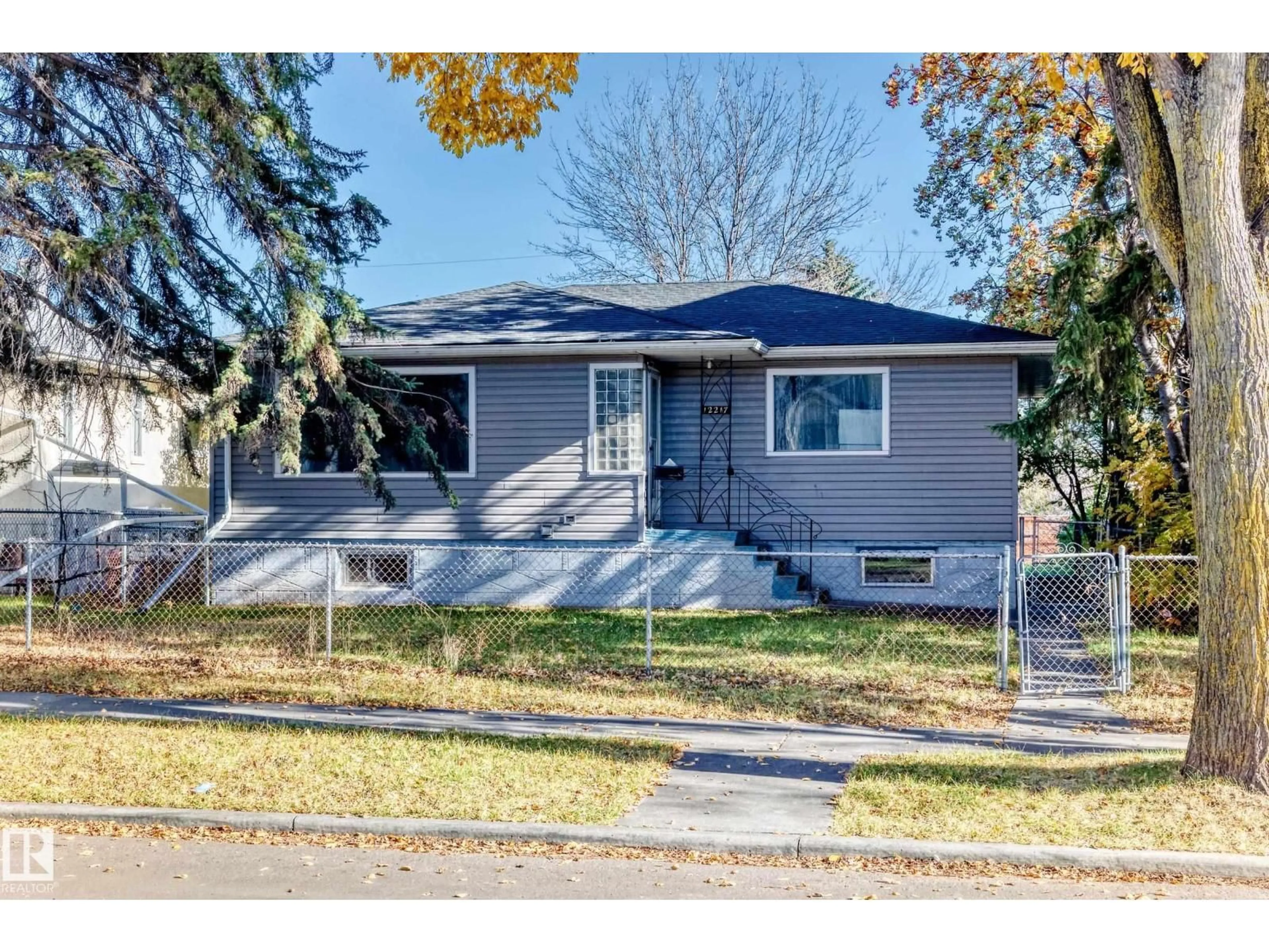 Home with vinyl exterior material, street for 12217 88 ST, Edmonton Alberta T5B3S7
