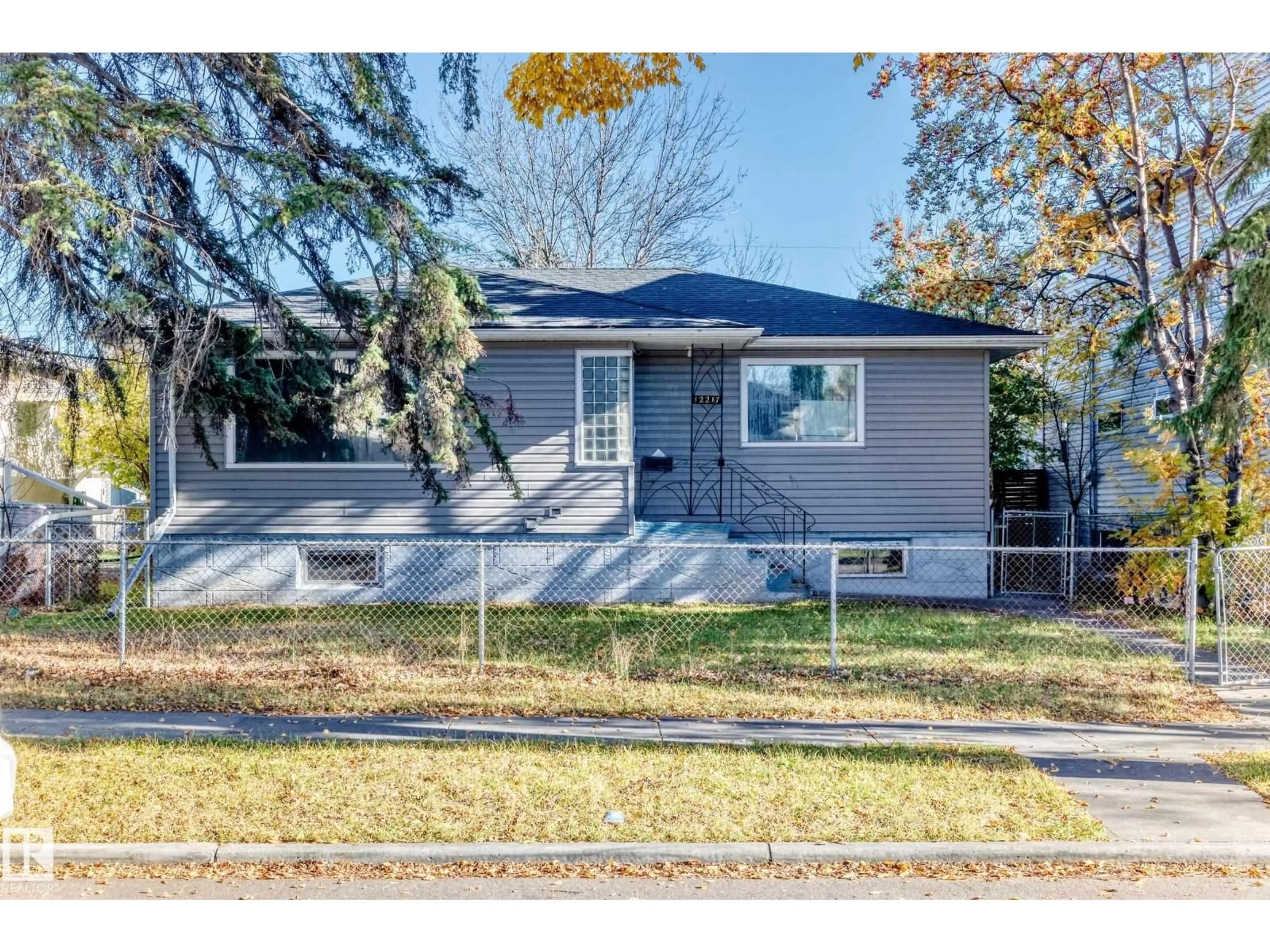 Home with vinyl exterior material, street for 12217 88 ST, Edmonton Alberta T5B3S7