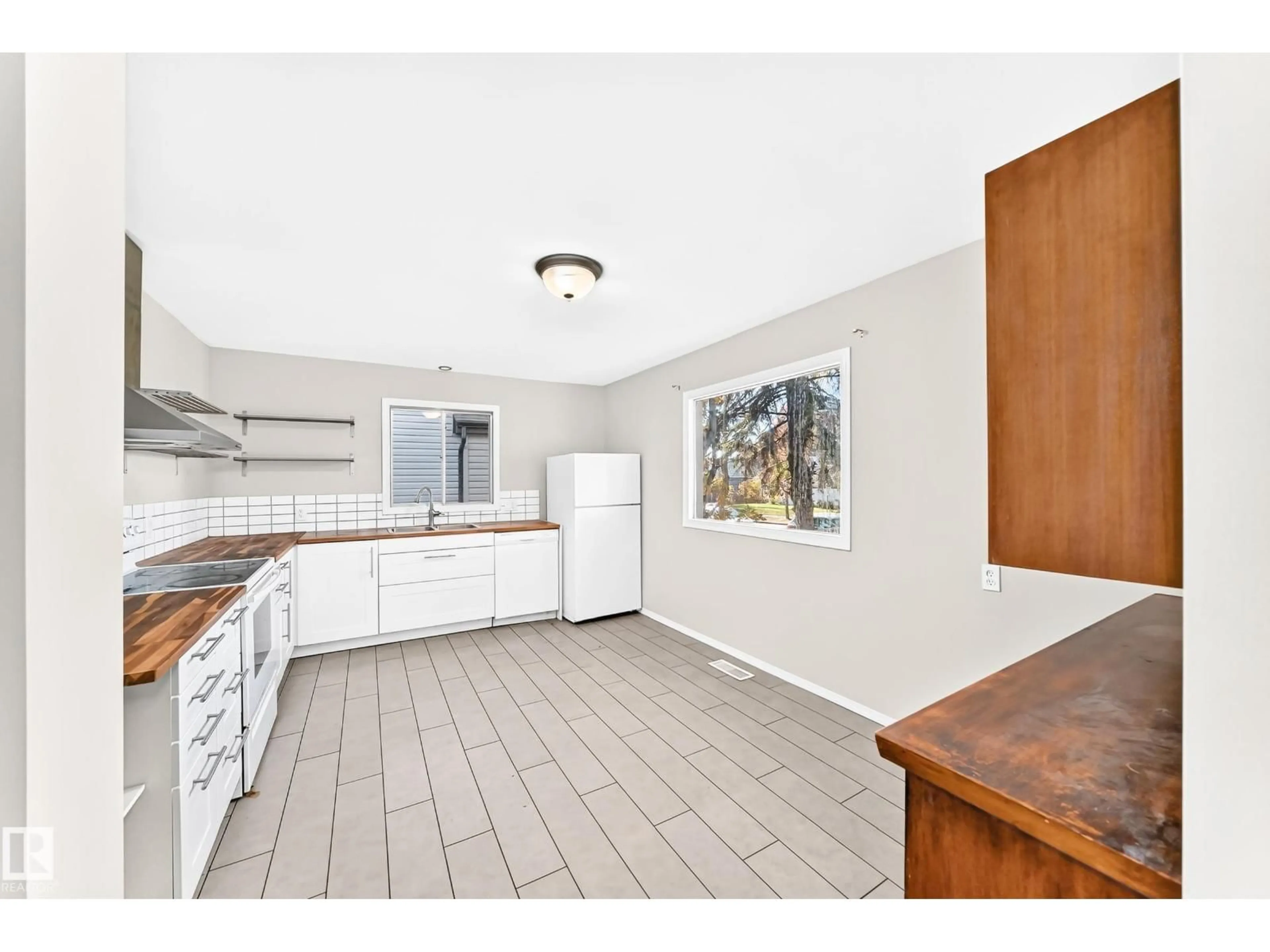 Open concept kitchen, ceramic/tile floor for 12217 88 ST, Edmonton Alberta T5B3S7