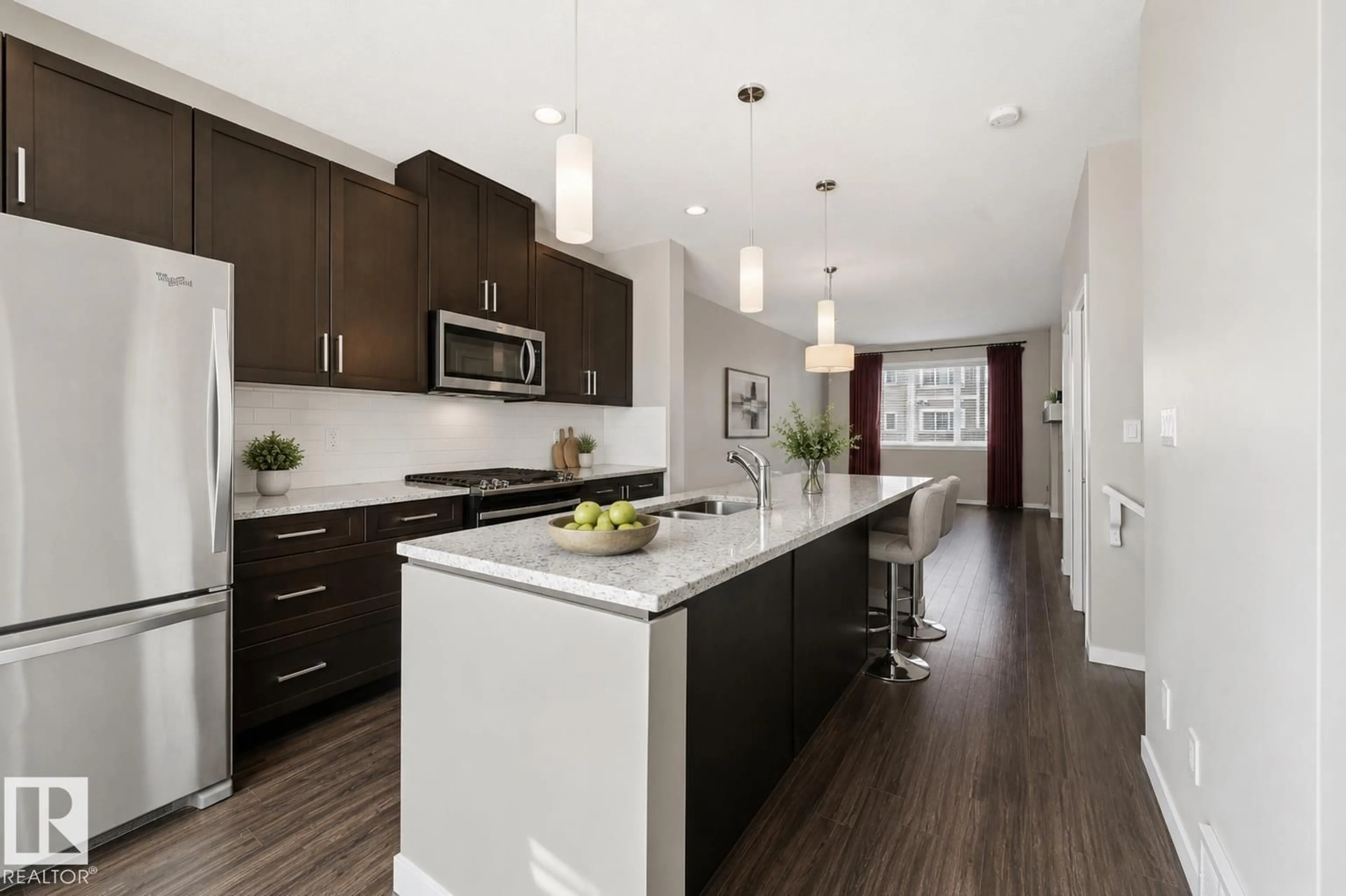 Open concept kitchen, wood/laminate floor for #4 - 320 SECORD BV, Edmonton Alberta T5T7E8