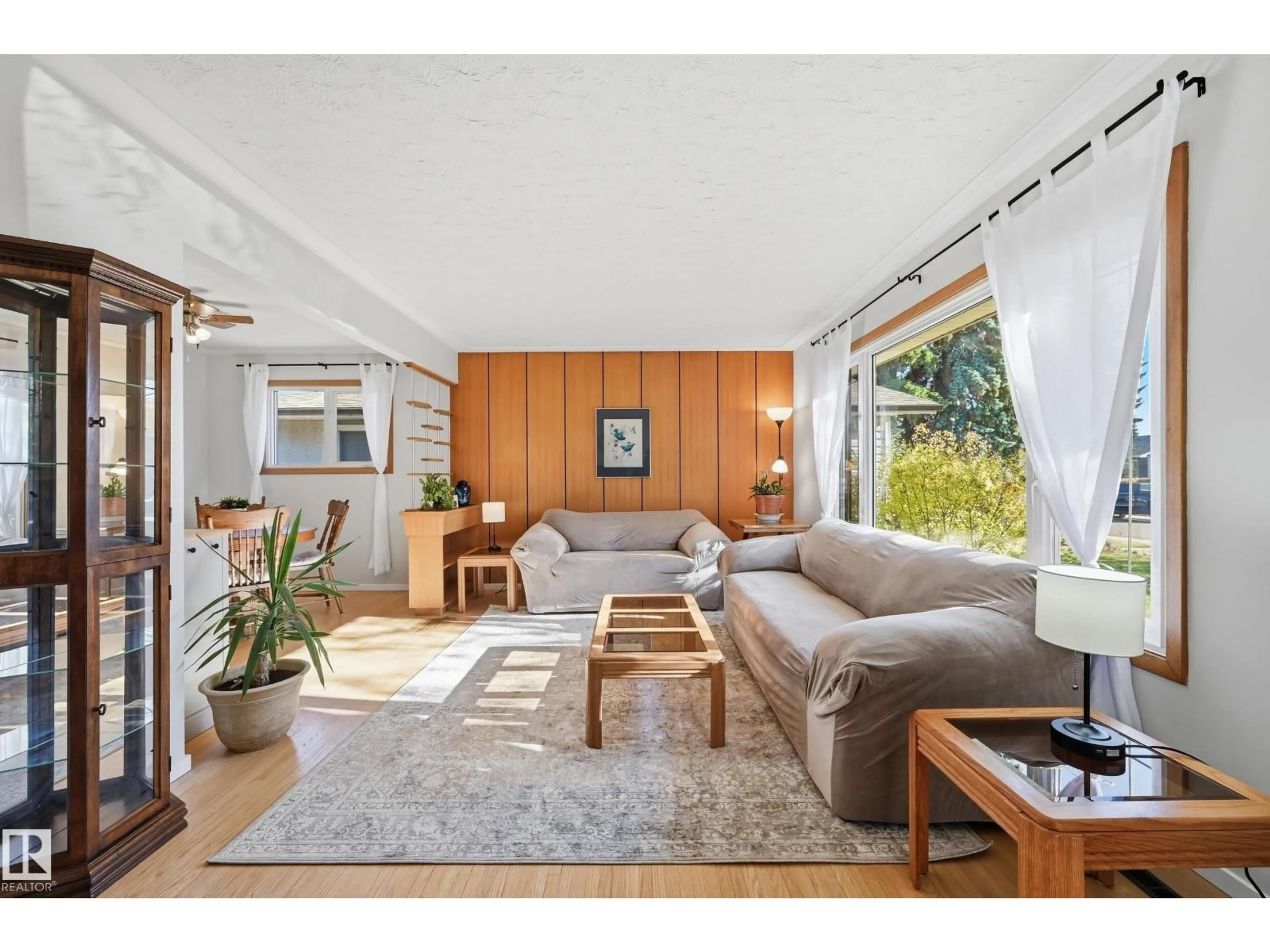 Living room with furniture, wood/laminate floor for 6604 93 AV, Edmonton Alberta T6B0W5