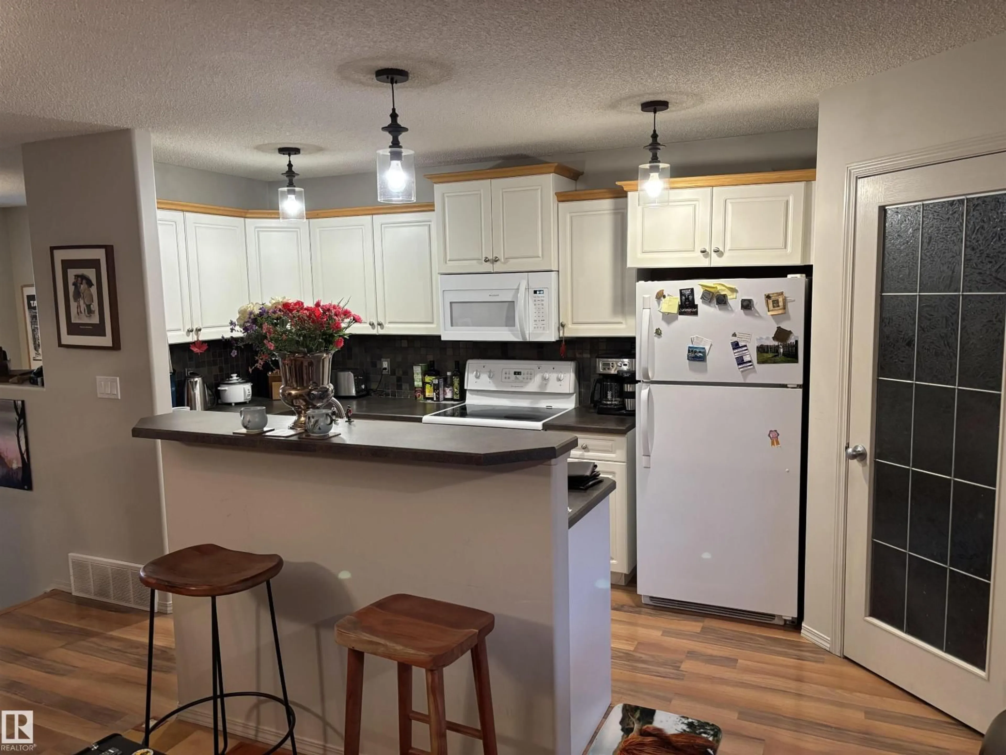 Open concept kitchen, wood/laminate floor for 711 KANANASKIS DR, Devon Alberta T9G2G7