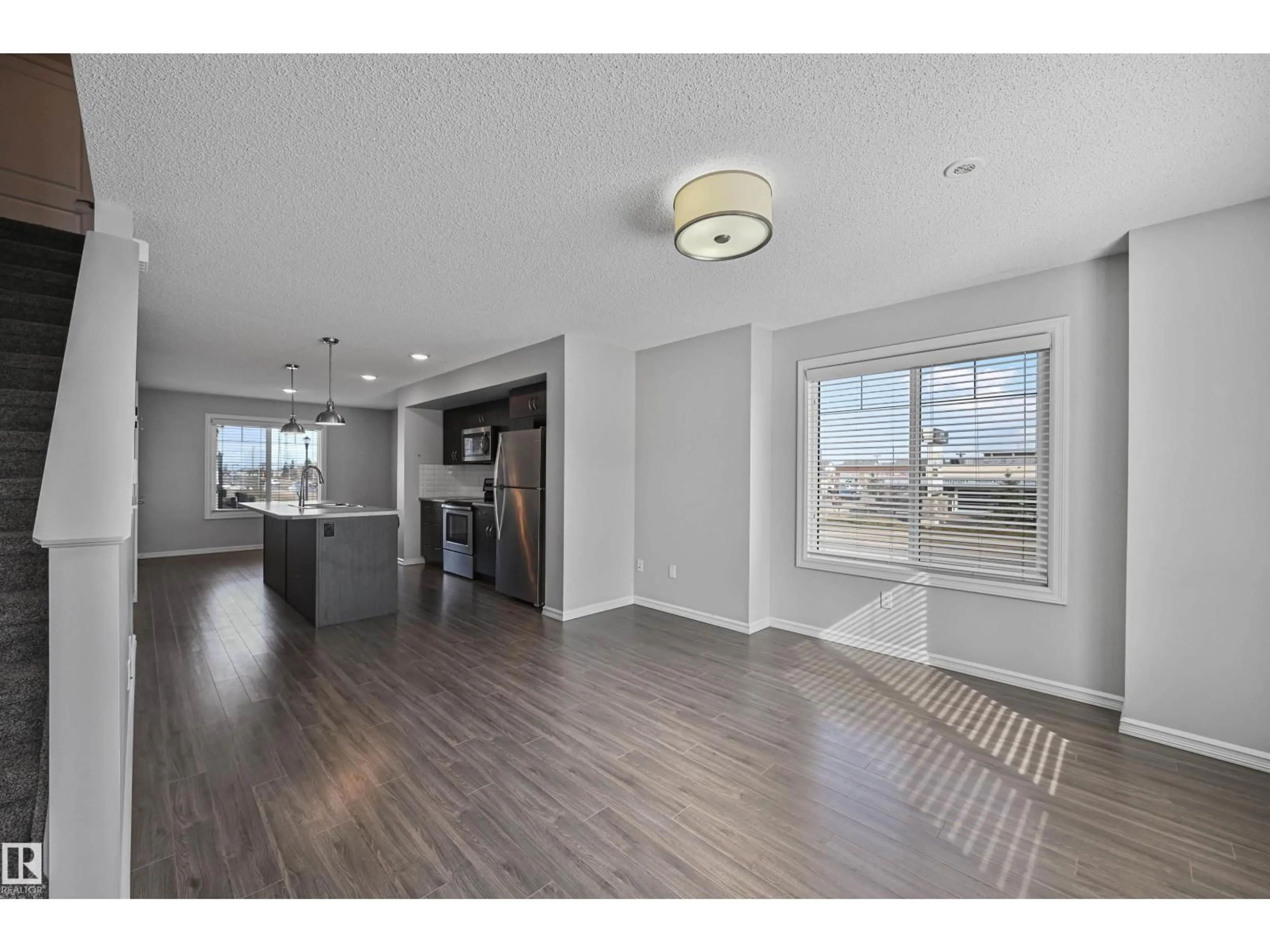 Open concept kitchen, wood/laminate floor for #34 - 2215 24 ST, Edmonton Alberta T6T1A6