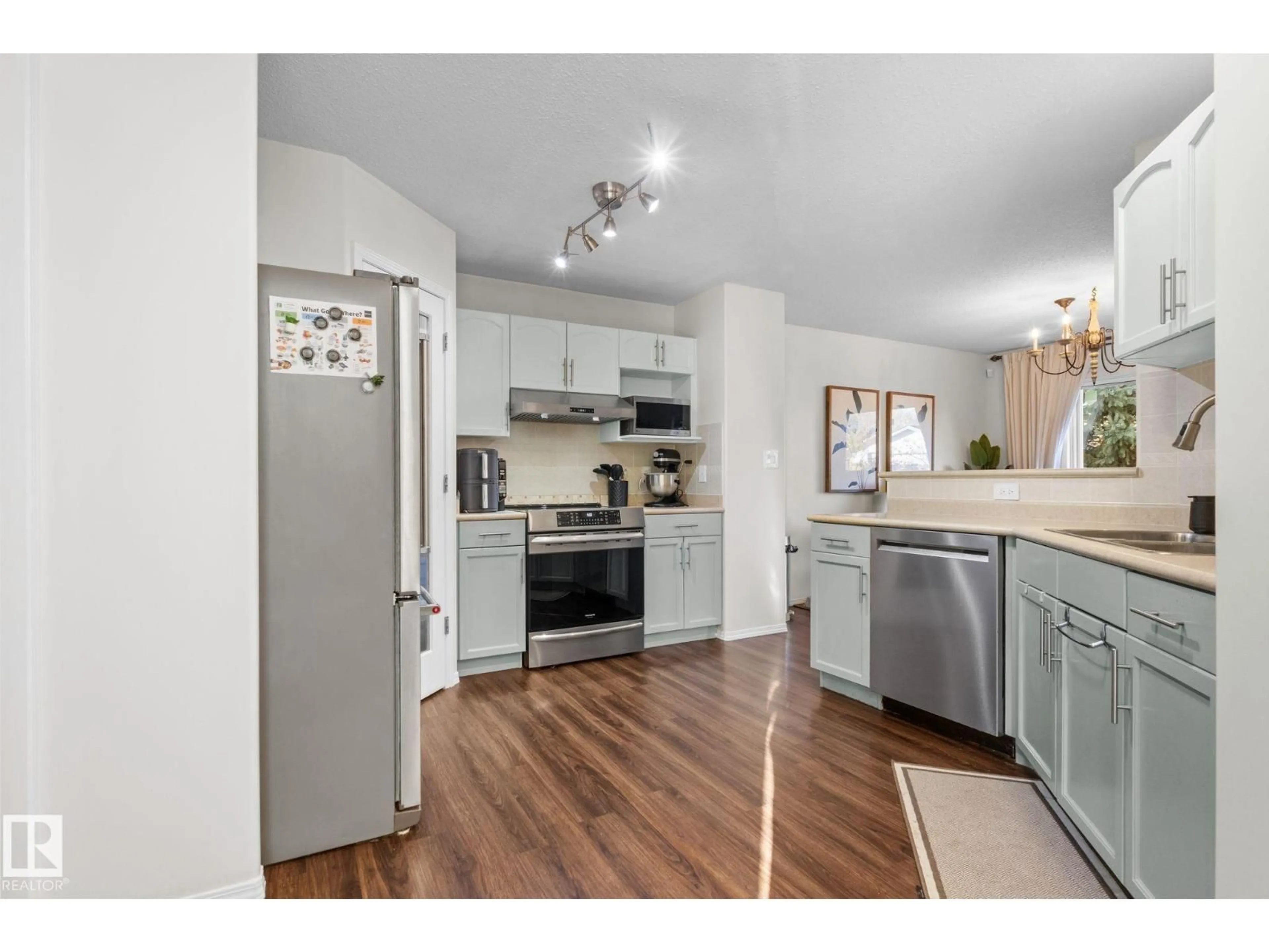 Open concept kitchen, wood/laminate floor for 1912 35A AV, Edmonton Alberta T6T1Y9