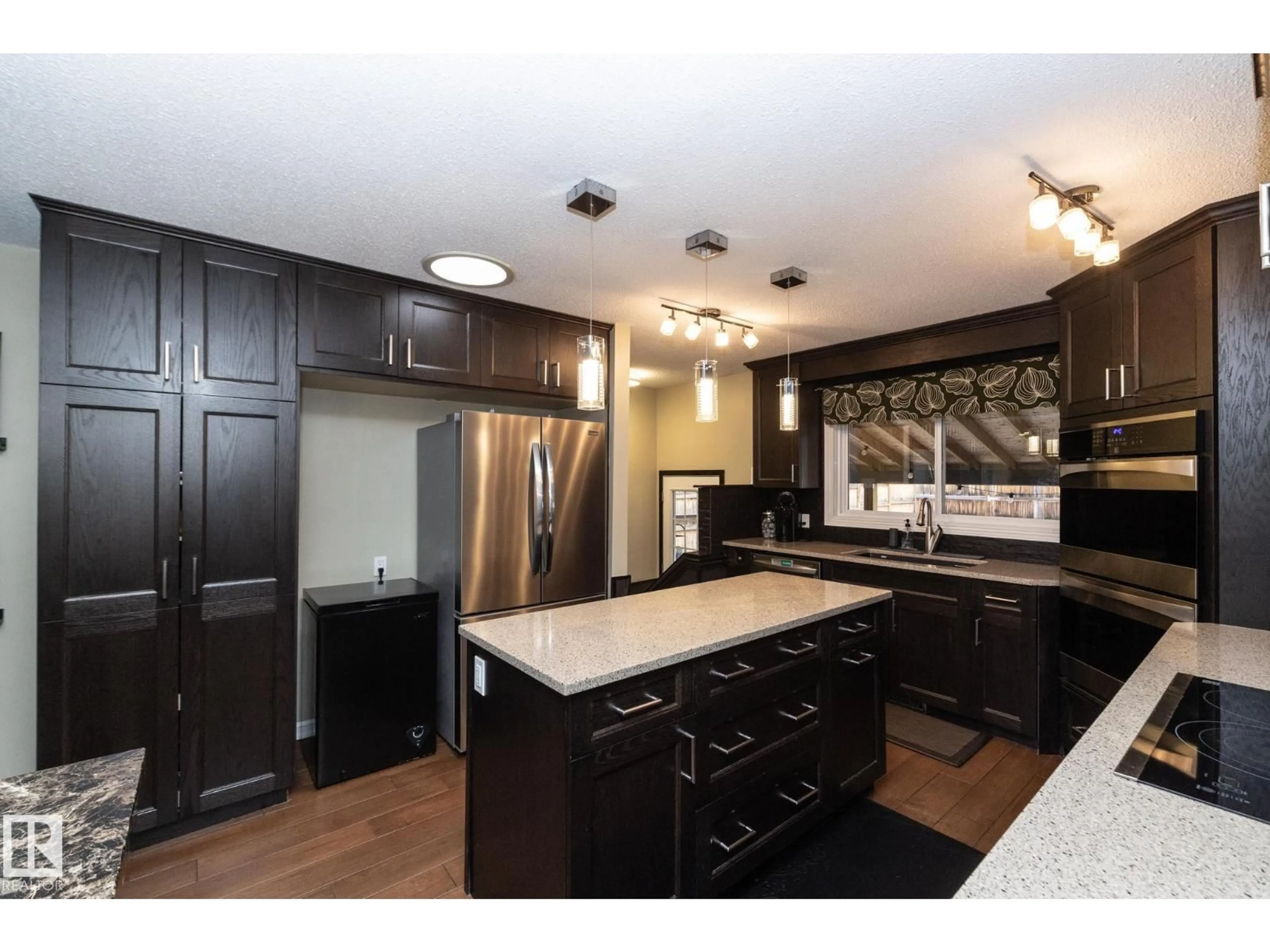 Open concept kitchen, wood/laminate floor for 7412 33 AV, Edmonton Alberta T6K1J4