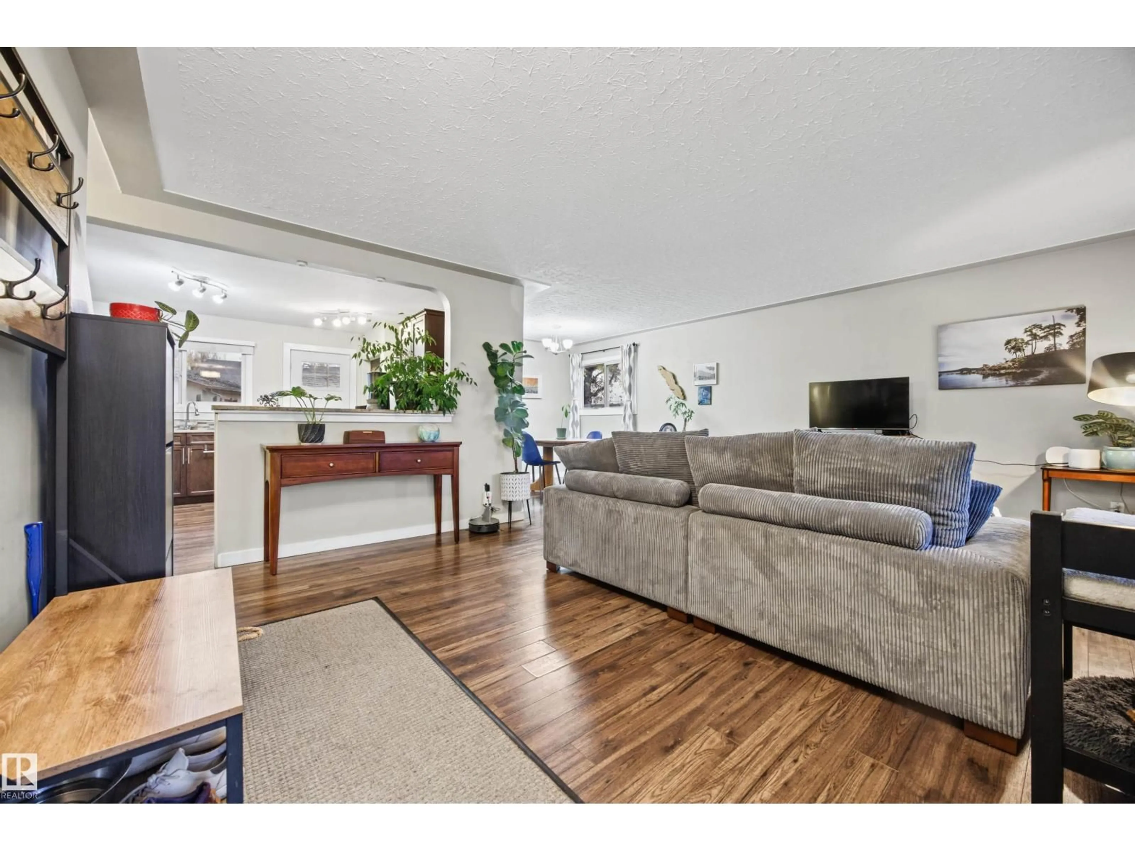 Living room with furniture, wood/laminate floor for 10235 FULTON RD, Edmonton Alberta T6A3T5