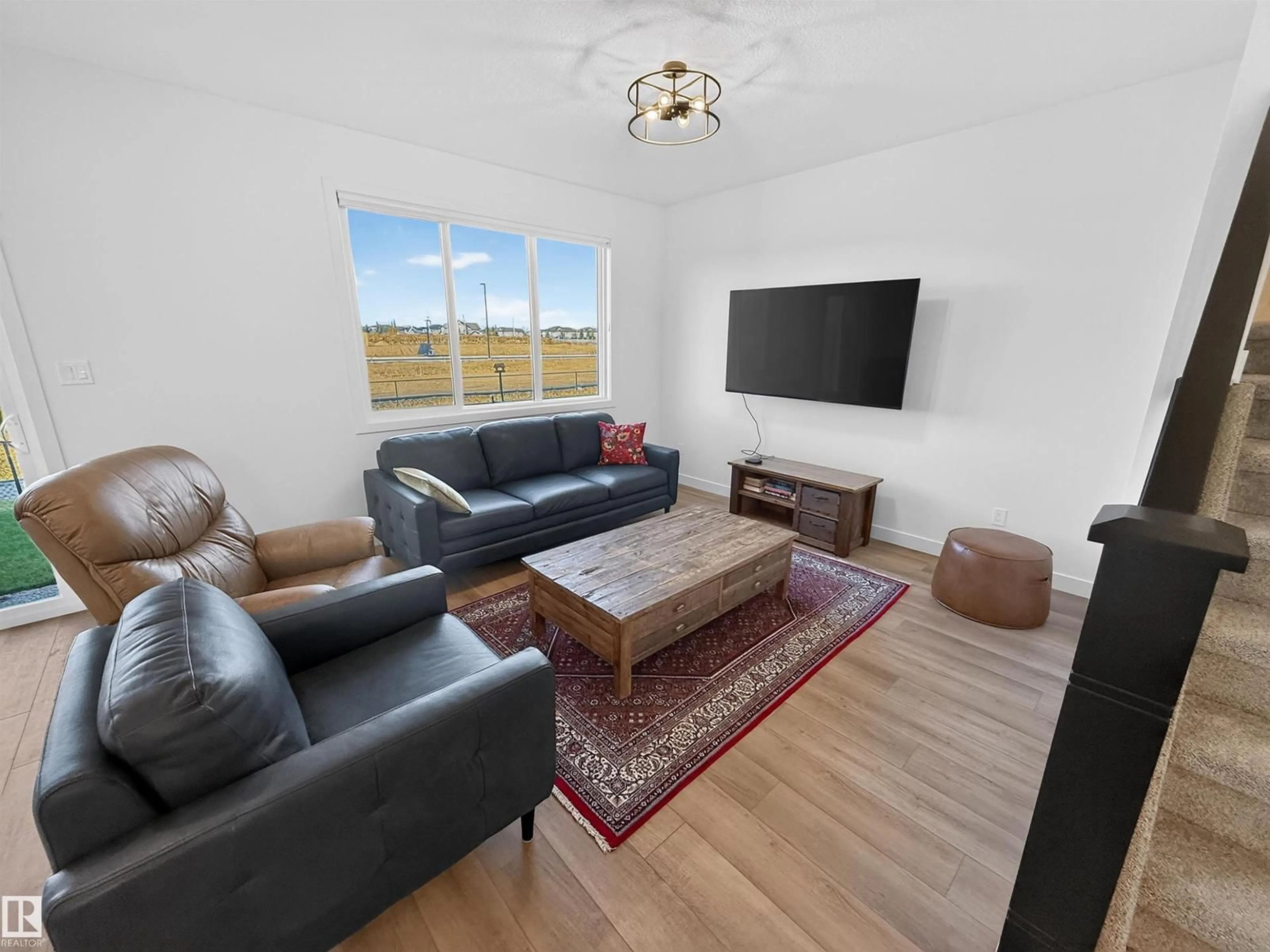 Living room with furniture, wood/laminate floor for 1734 WESTERRA WD, Stony Plain Alberta T7Z0P1