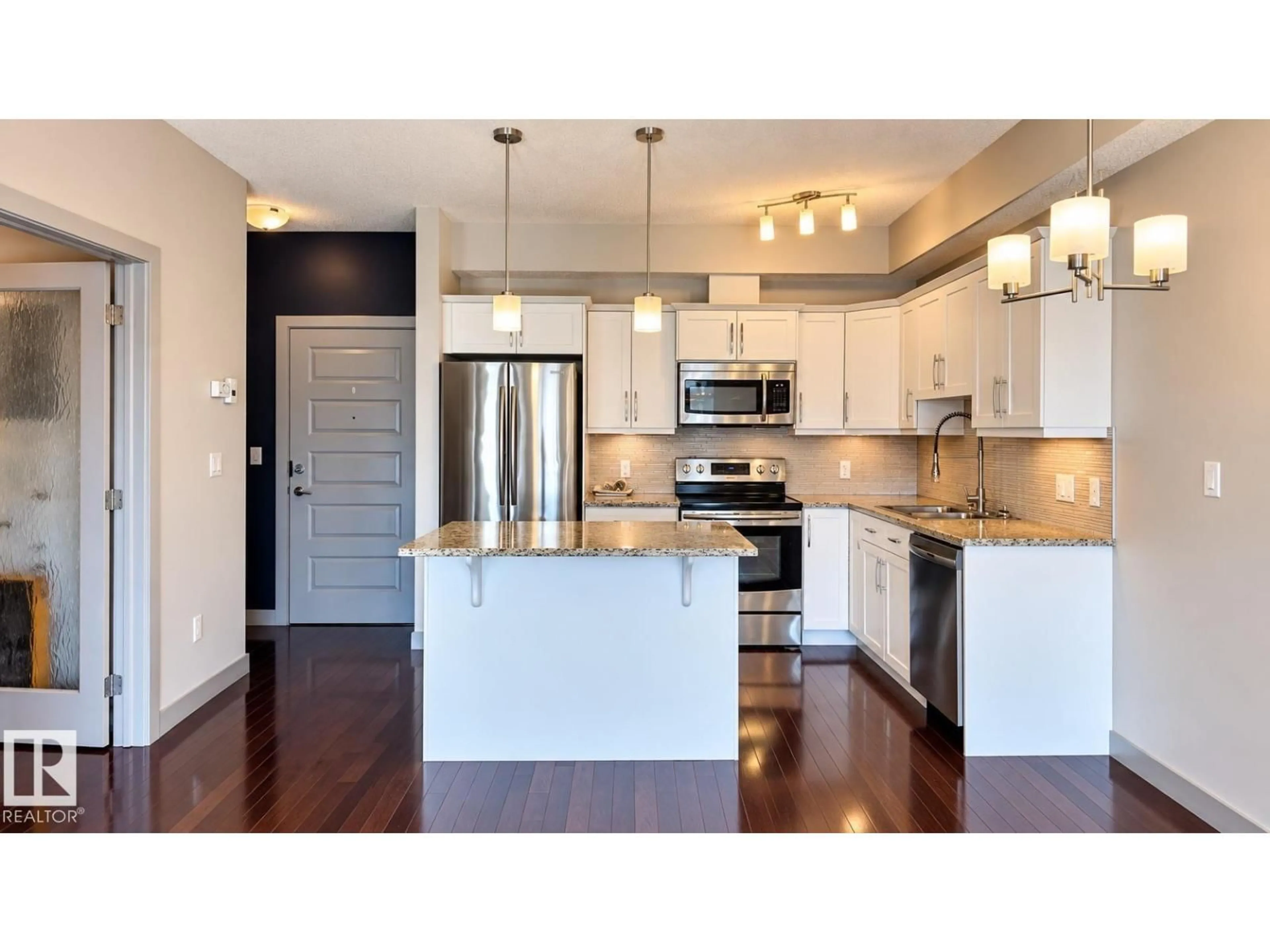Open concept kitchen, wood/laminate floor for 201 - 10530 56 AV, Edmonton Alberta T6H0X7