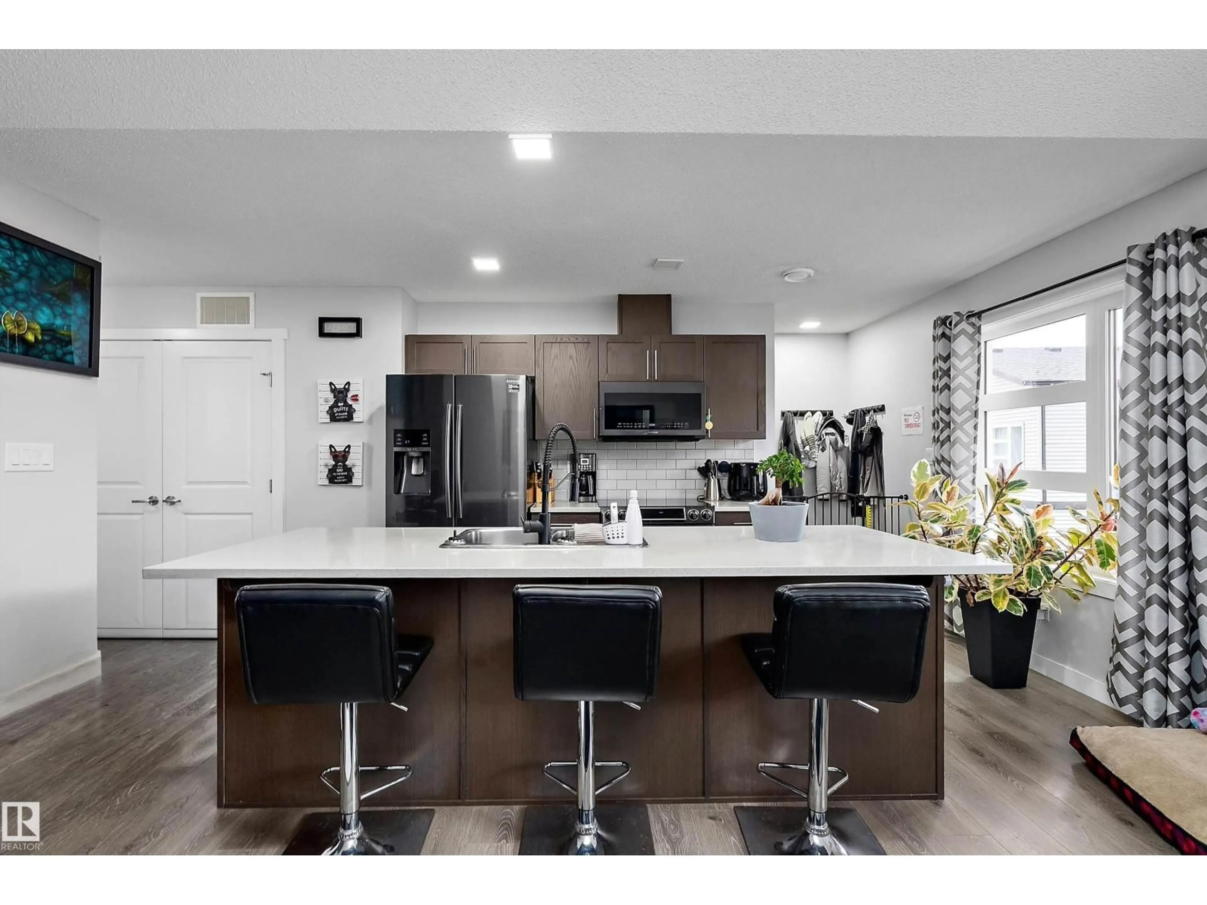 Open concept kitchen, wood/laminate floor for 69 1203 163 ST SW, Edmonton Alberta T6W3X1