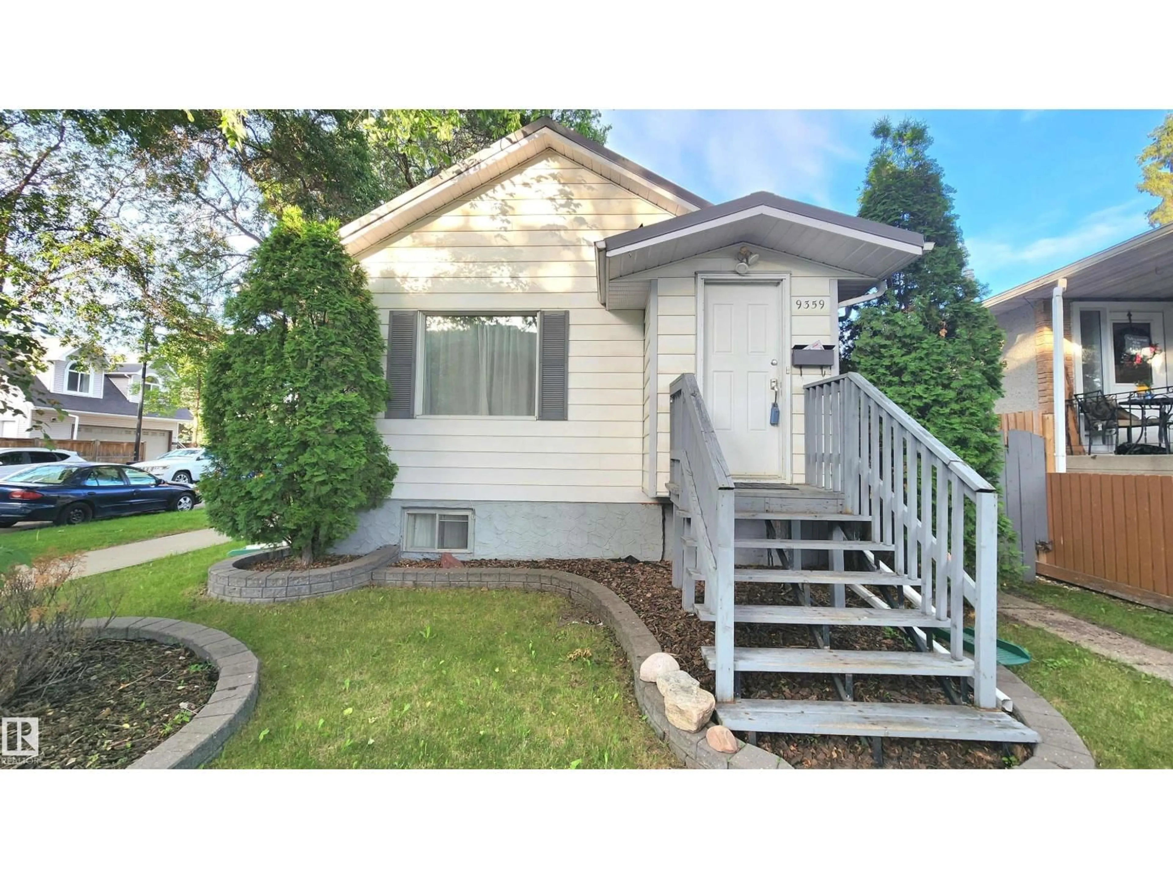 Home with vinyl exterior material, street for 9359 92 ST, Edmonton Alberta T6C3R8