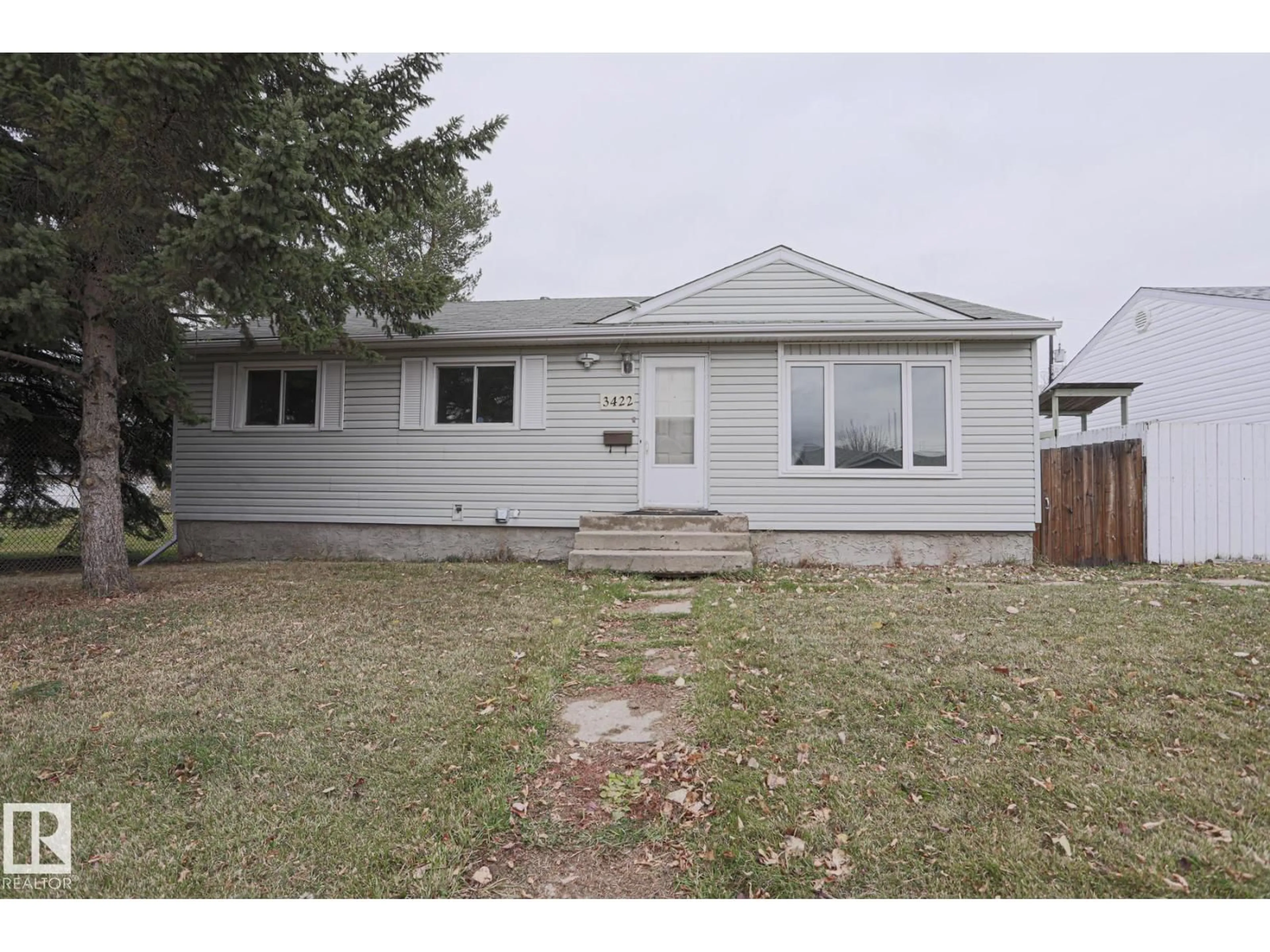 Home with vinyl exterior material, street for NW - 3422 119A AV, Edmonton Alberta T5W1J9