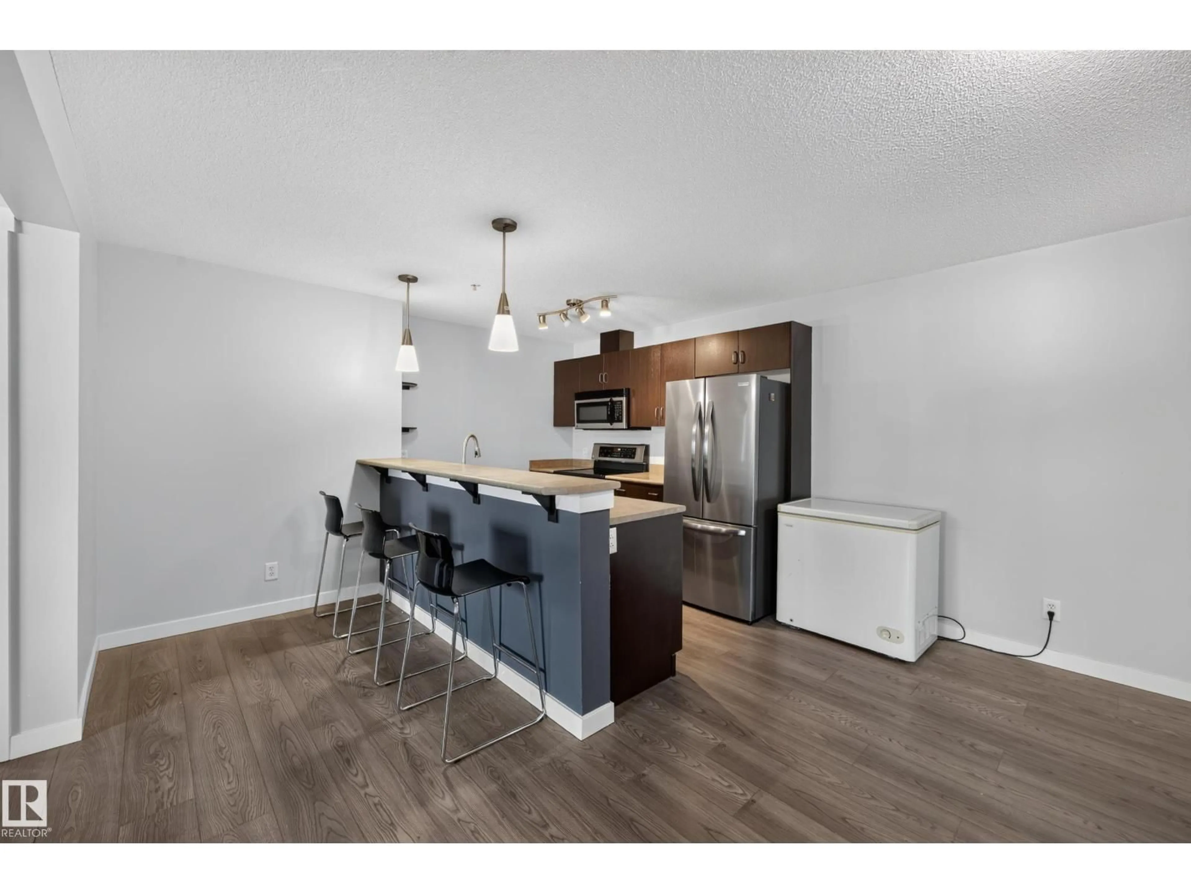 Open concept kitchen, wood/laminate floor for #326 - 1180 HYNDMAN RD, Edmonton Alberta T5A0P8