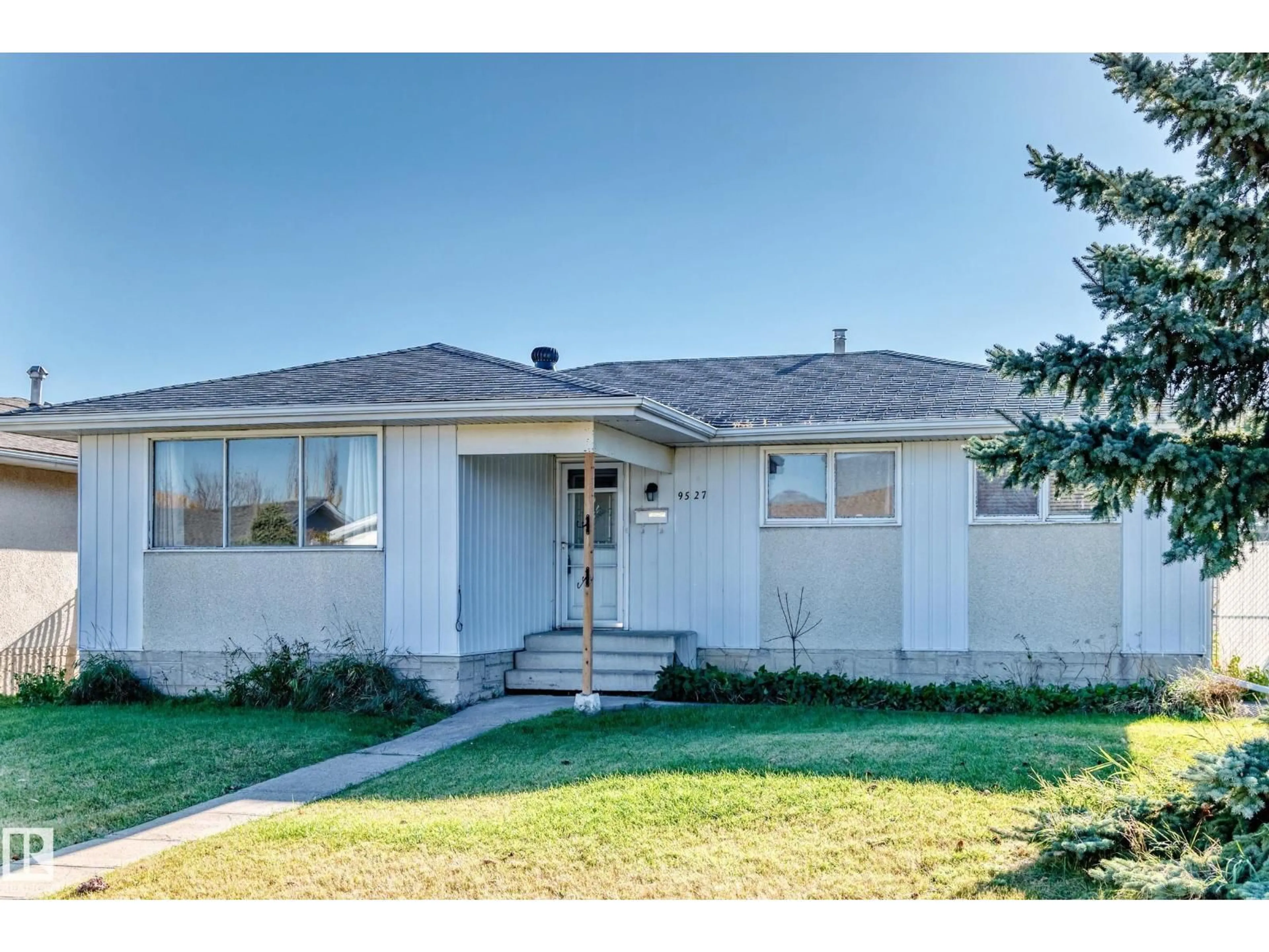 Home with vinyl exterior material, street for 9527 139 AV, Edmonton Alberta T5E5Z7
