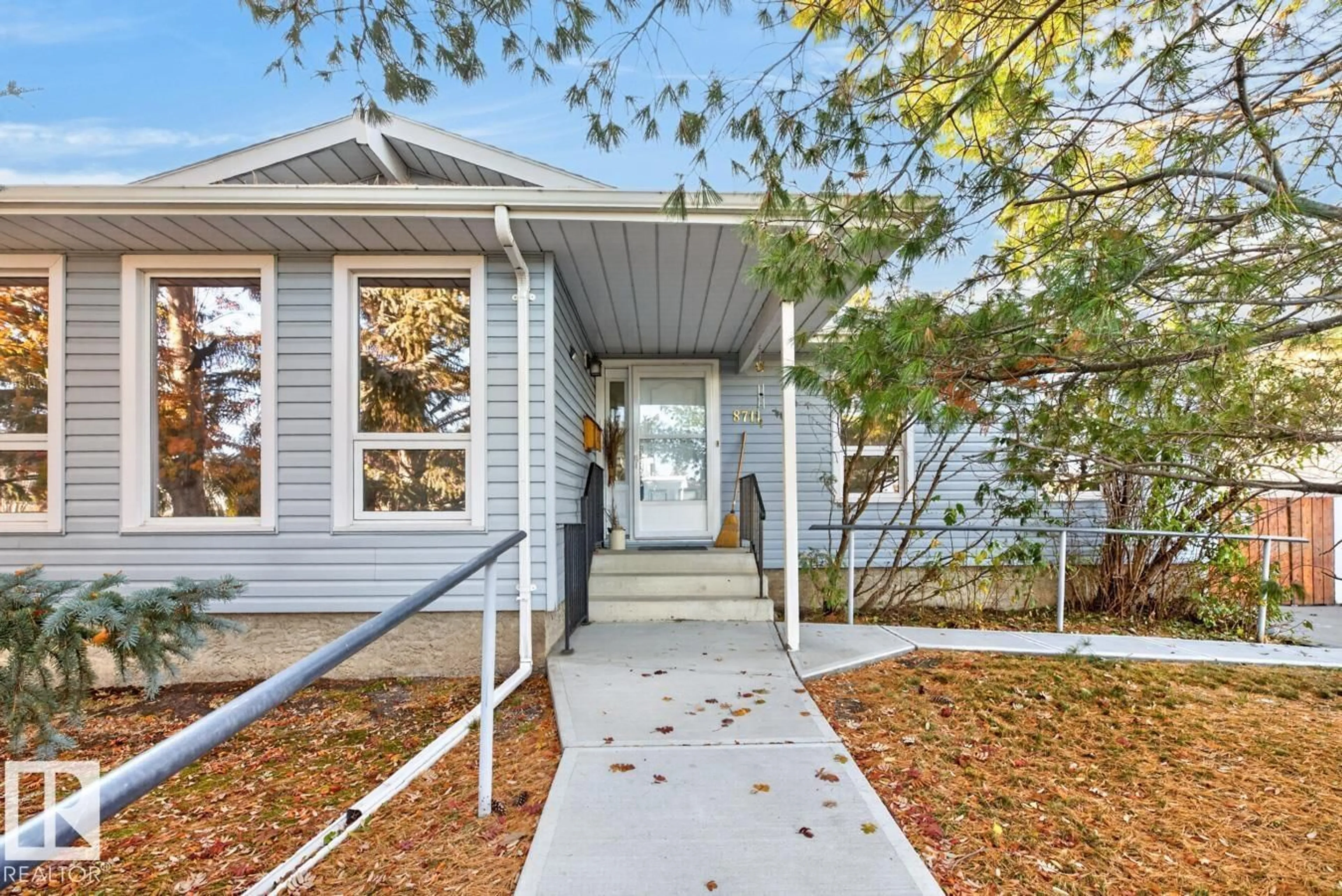Home with vinyl exterior material, street for NW - 8711 38A AV, Edmonton Alberta T6K0E7