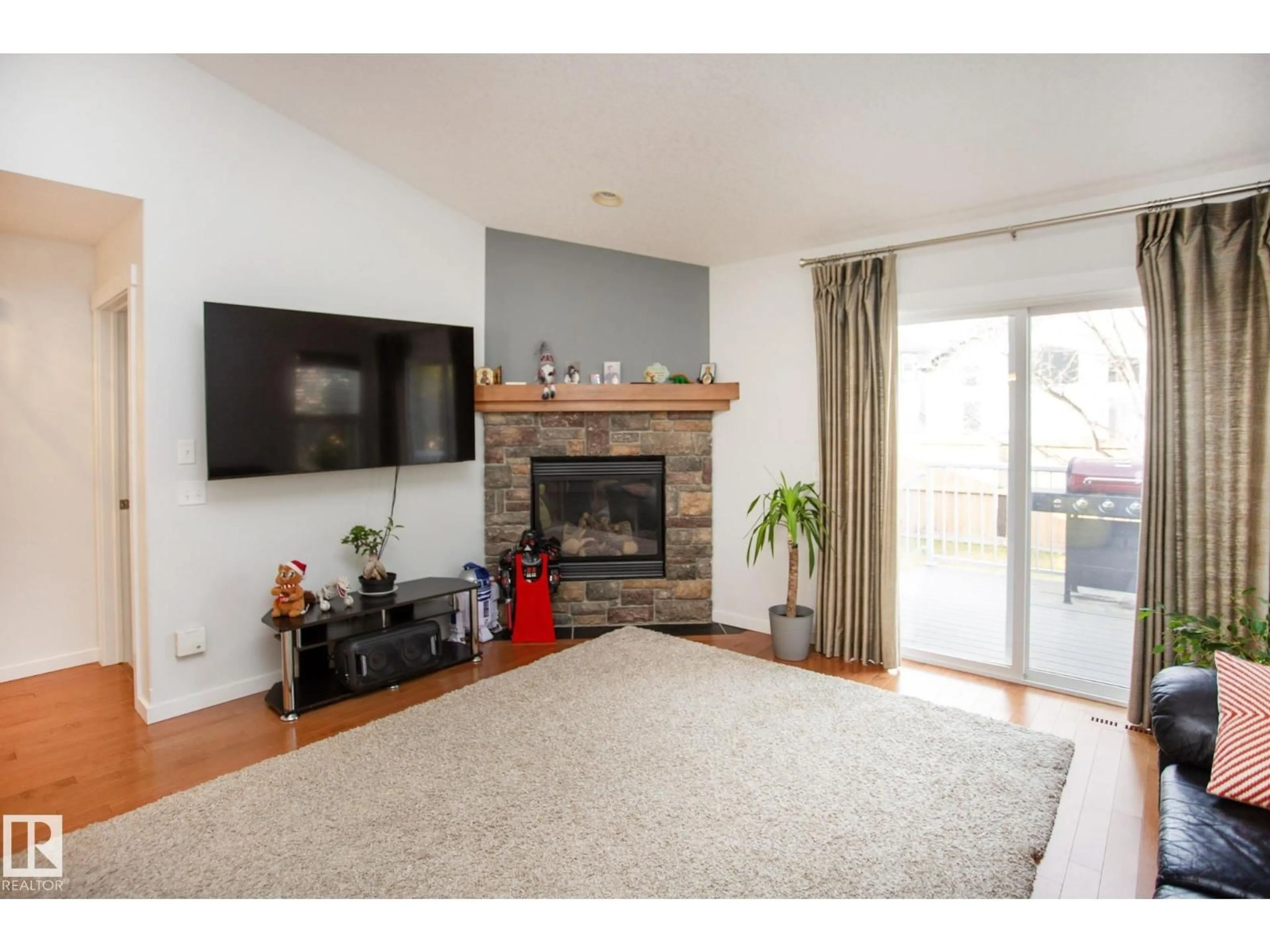 Living room with furniture, wood/laminate floor for 14 NEVIS CL, St. Albert Alberta T8N0R5