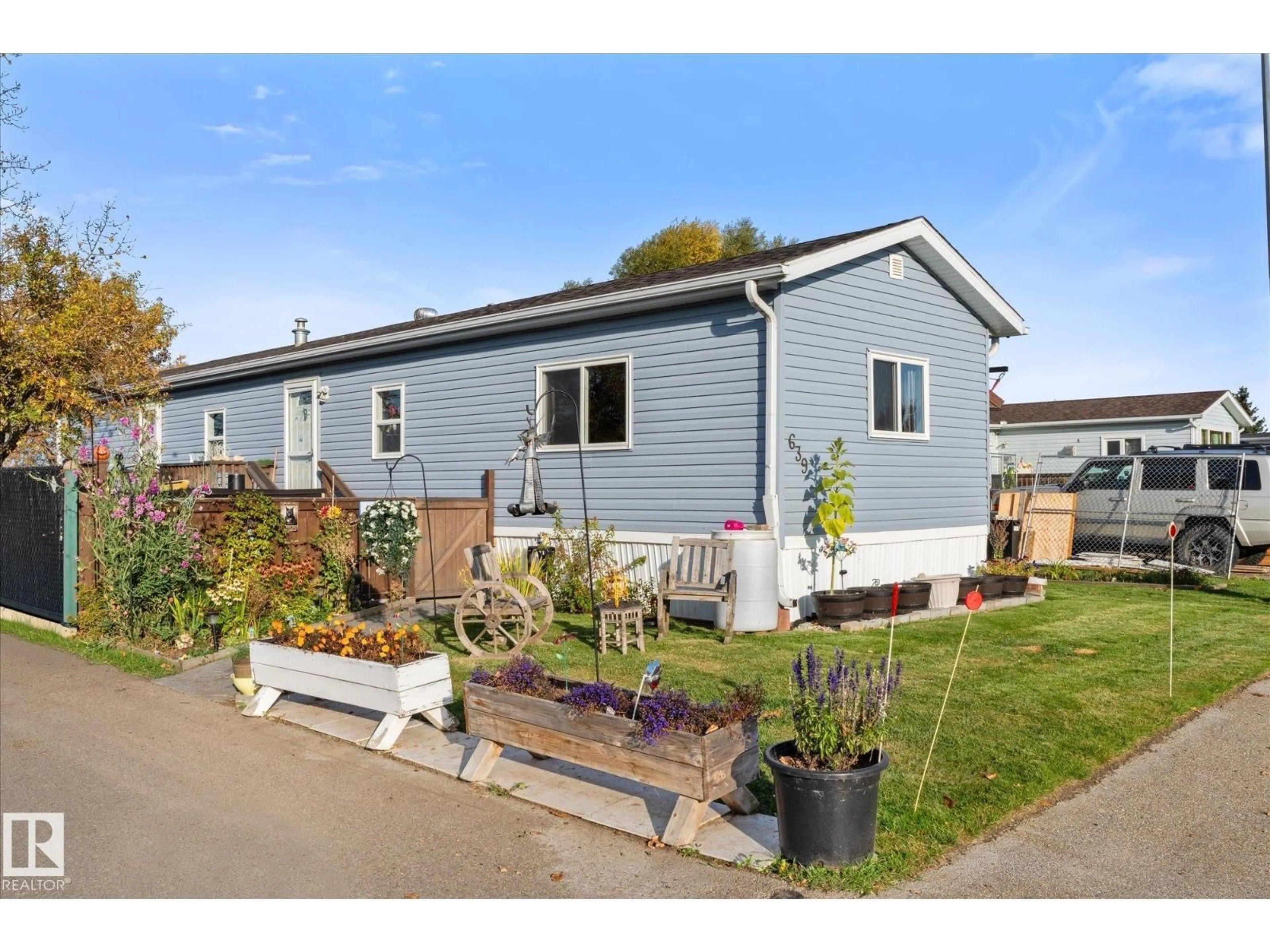 Home with vinyl exterior material, street for 639 53222 RGE RD 272, Rural Parkland County Alberta T7X3P7