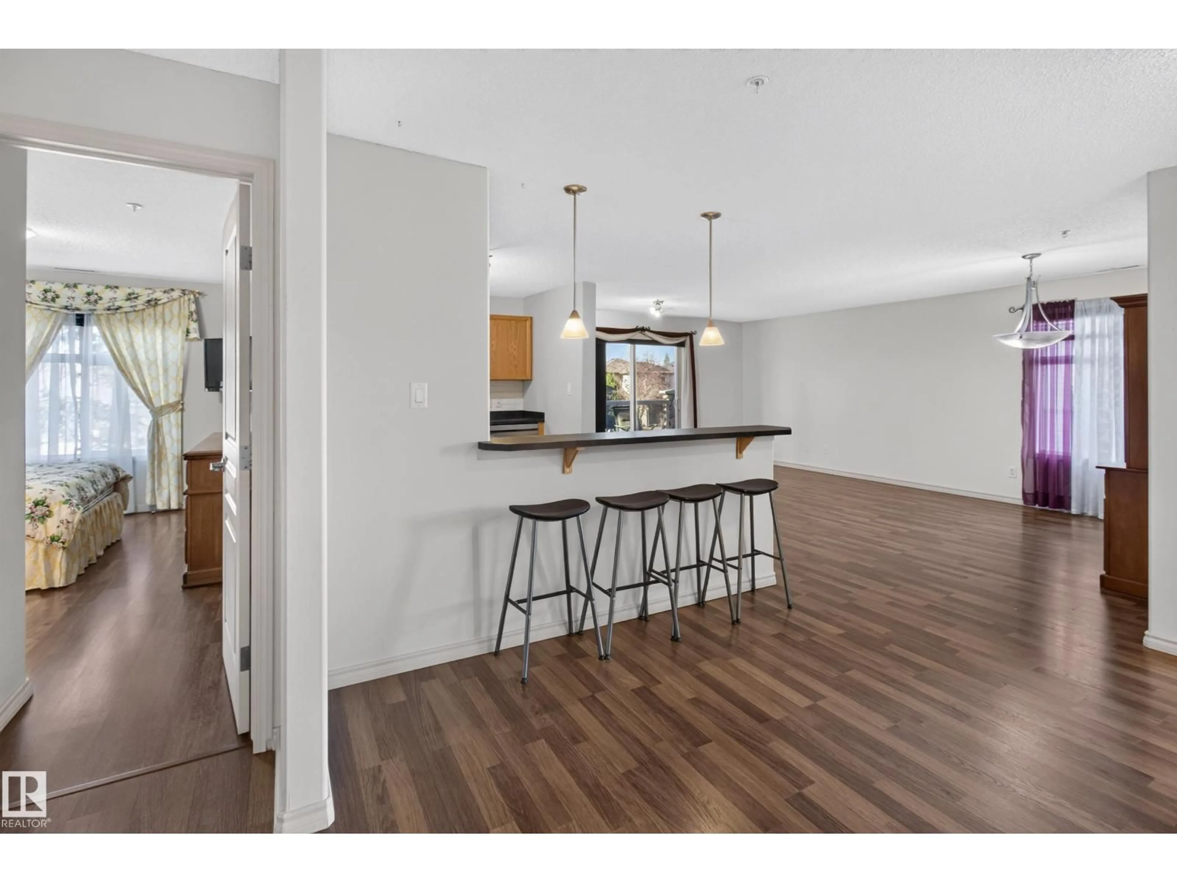Open concept kitchen, wood/laminate floor for #201 - 16035 132 ST, Edmonton Alberta T6V0B4