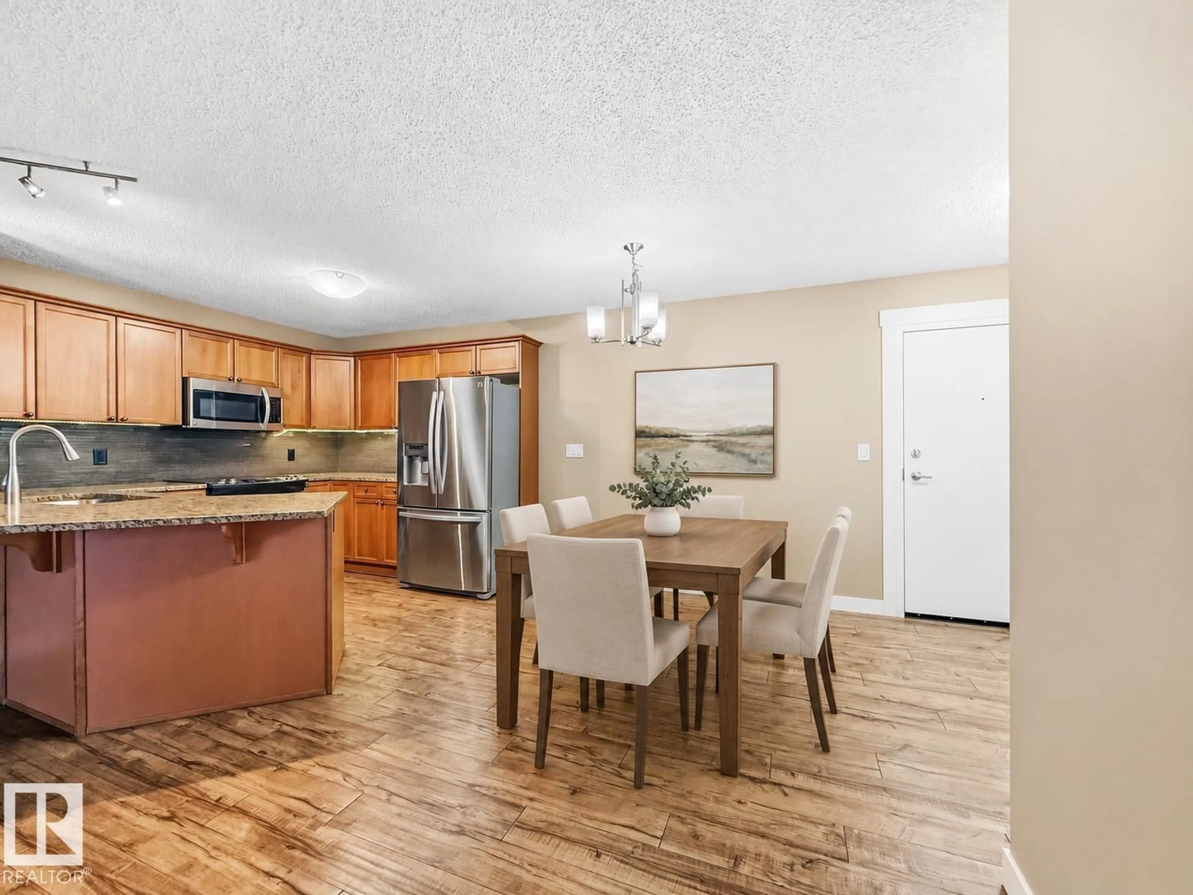Open concept kitchen, wood/laminate floor for #406 - 13830 150 AV, Edmonton Alberta T6V1X2