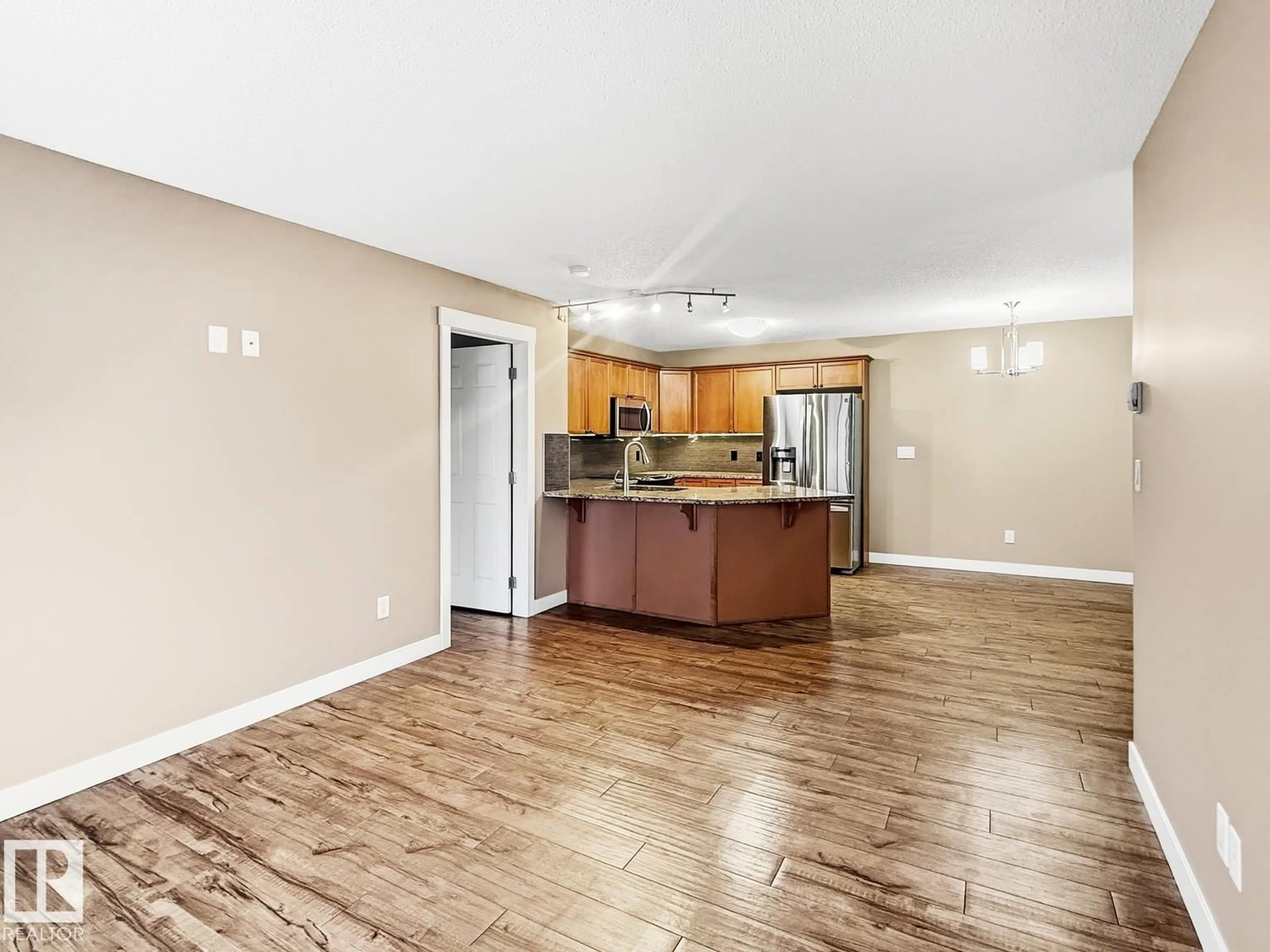 Open concept kitchen, wood/laminate floor for #406 - 13830 150 AV, Edmonton Alberta T6V1X2