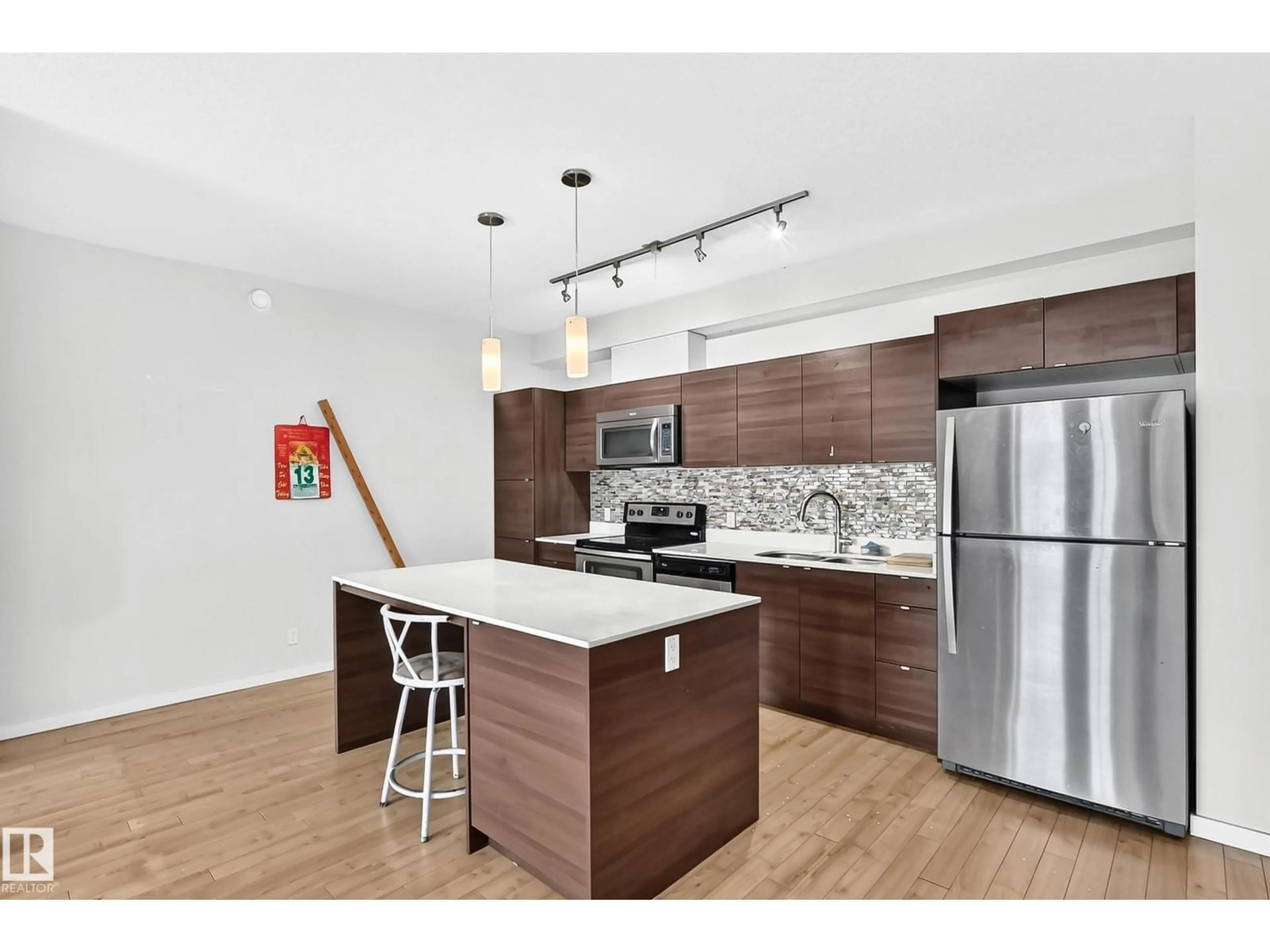 Open concept kitchen, wood/laminate floor for #403 - 9519 160 AV, Edmonton Alberta T5Z0N1