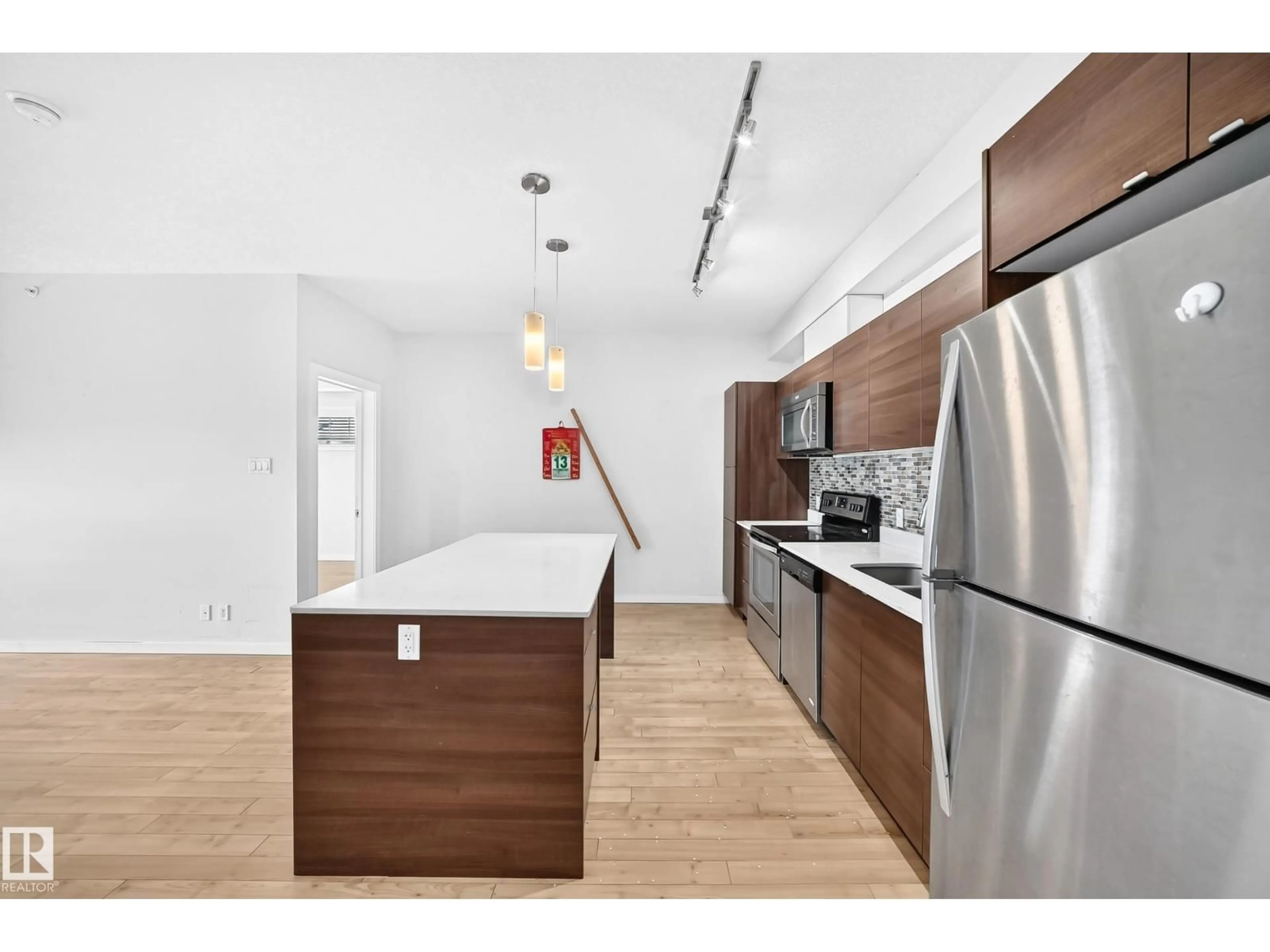 Open concept kitchen, wood/laminate floor for #403 - 9519 160 AV, Edmonton Alberta T5Z0N1