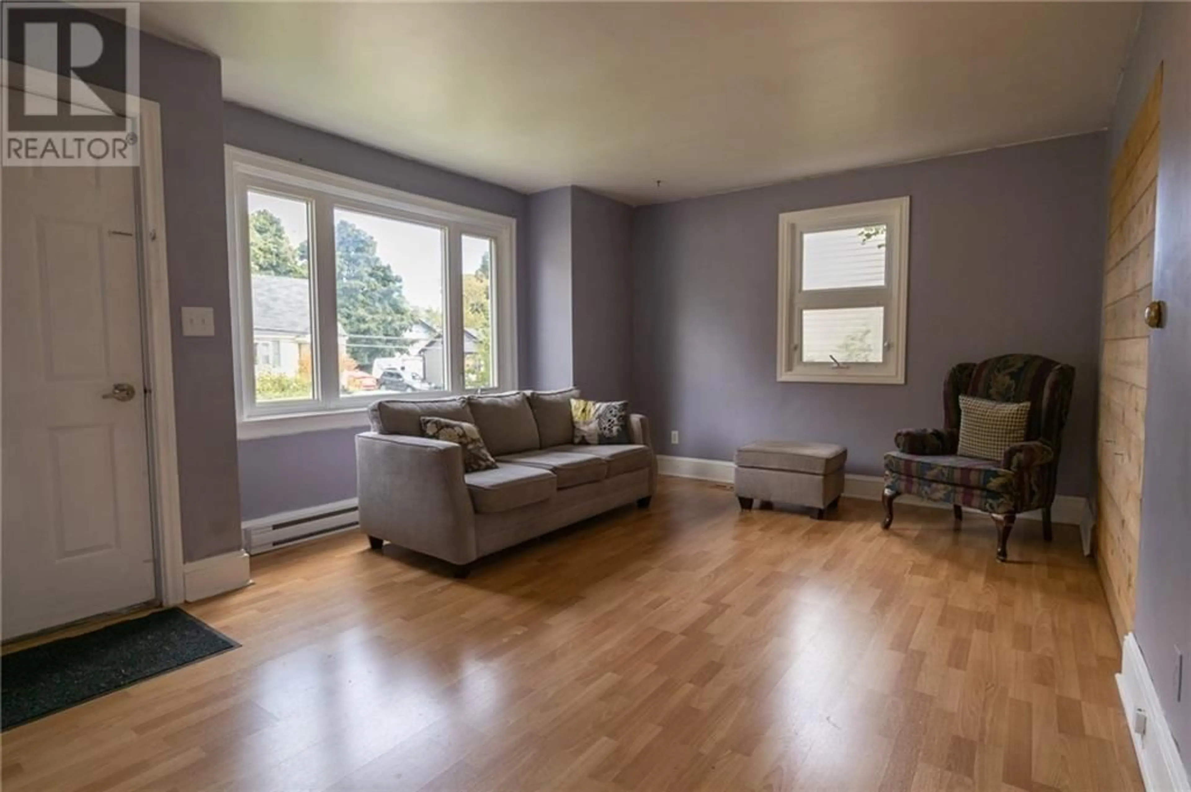 Living room with furniture, wood/laminate floor for 110 Braemar Drive, Moncton New Brunswick E1A3T1