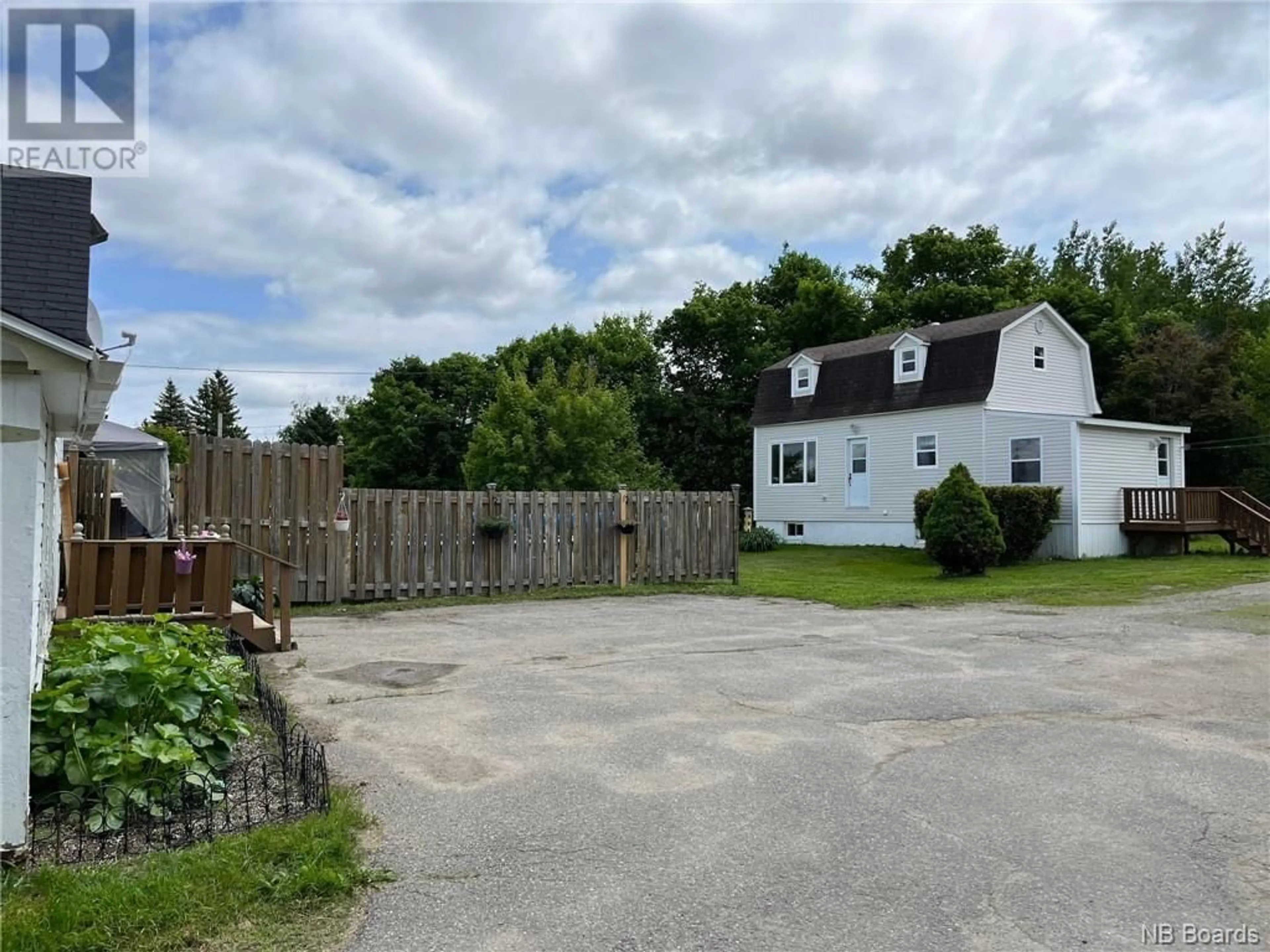 Frontside or backside of a home, the fenced backyard for 4430 Water Street, Miramichi New Brunswick E1N4L7