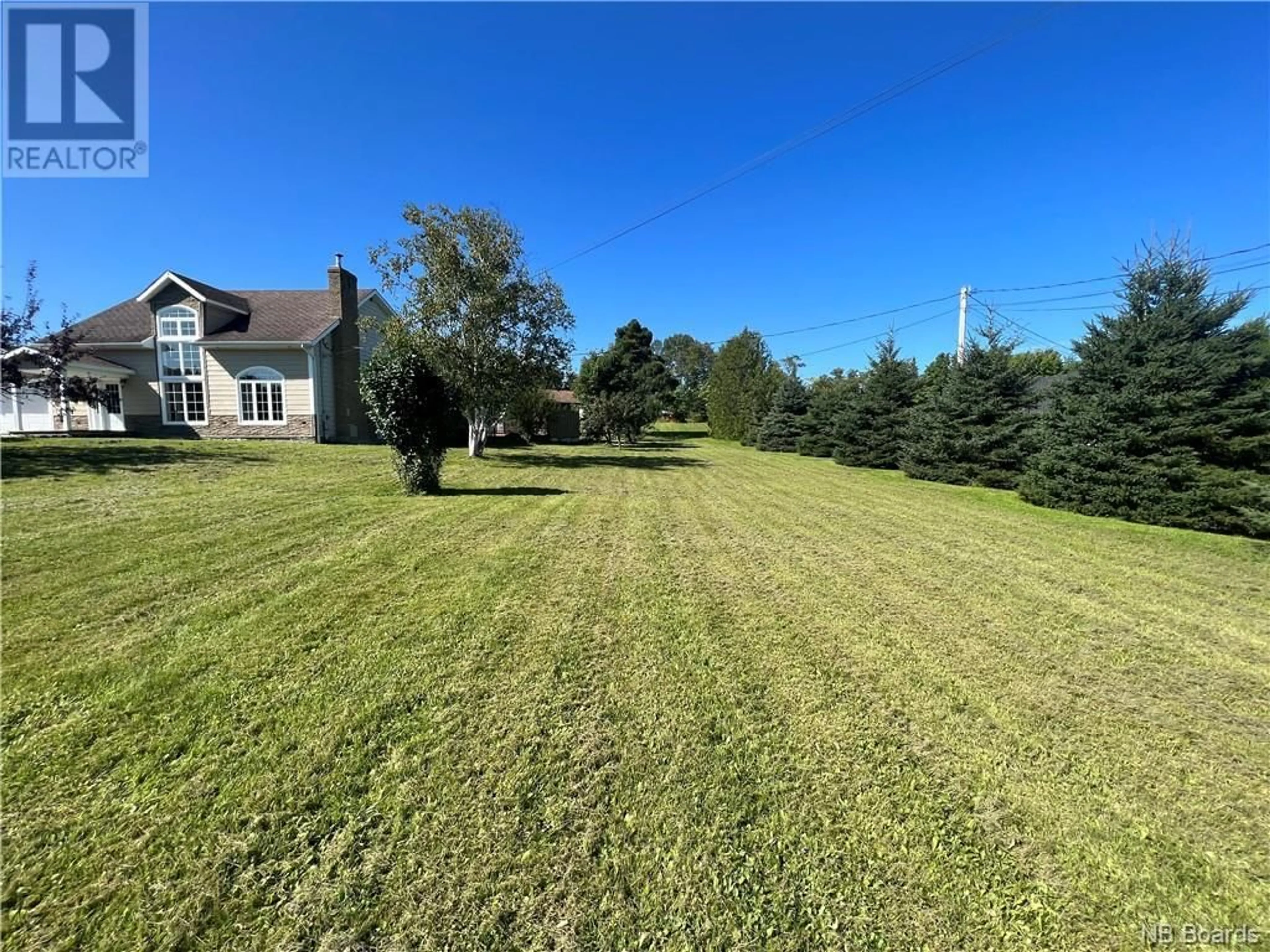 Frontside or backside of a home, the fenced backyard for 245 Rue Marcoux, Balmoral New Brunswick E8E1J3