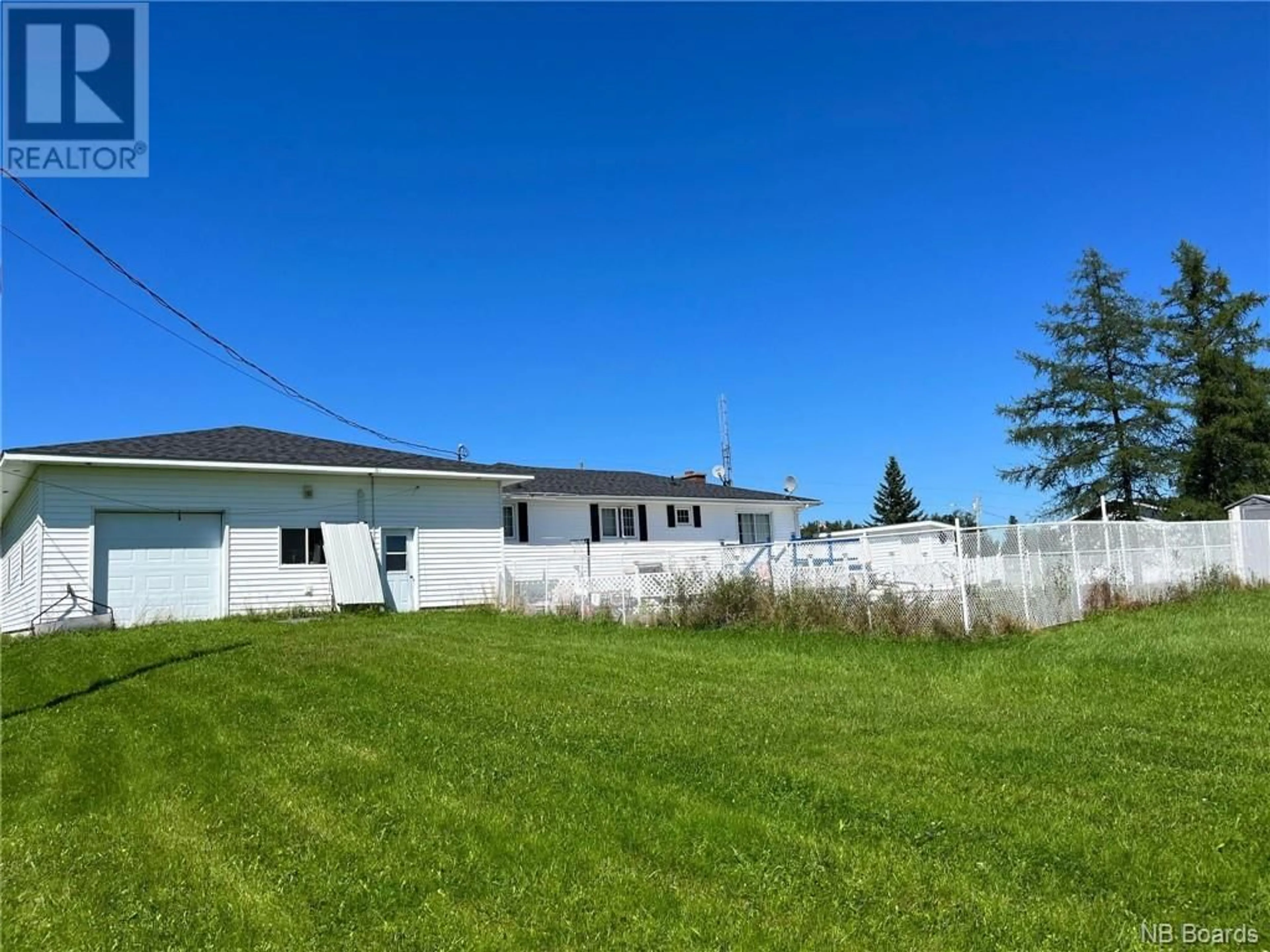 Frontside or backside of a home, the fenced backyard for 21 MacLaggan Drive, Blackville New Brunswick E9B1T5