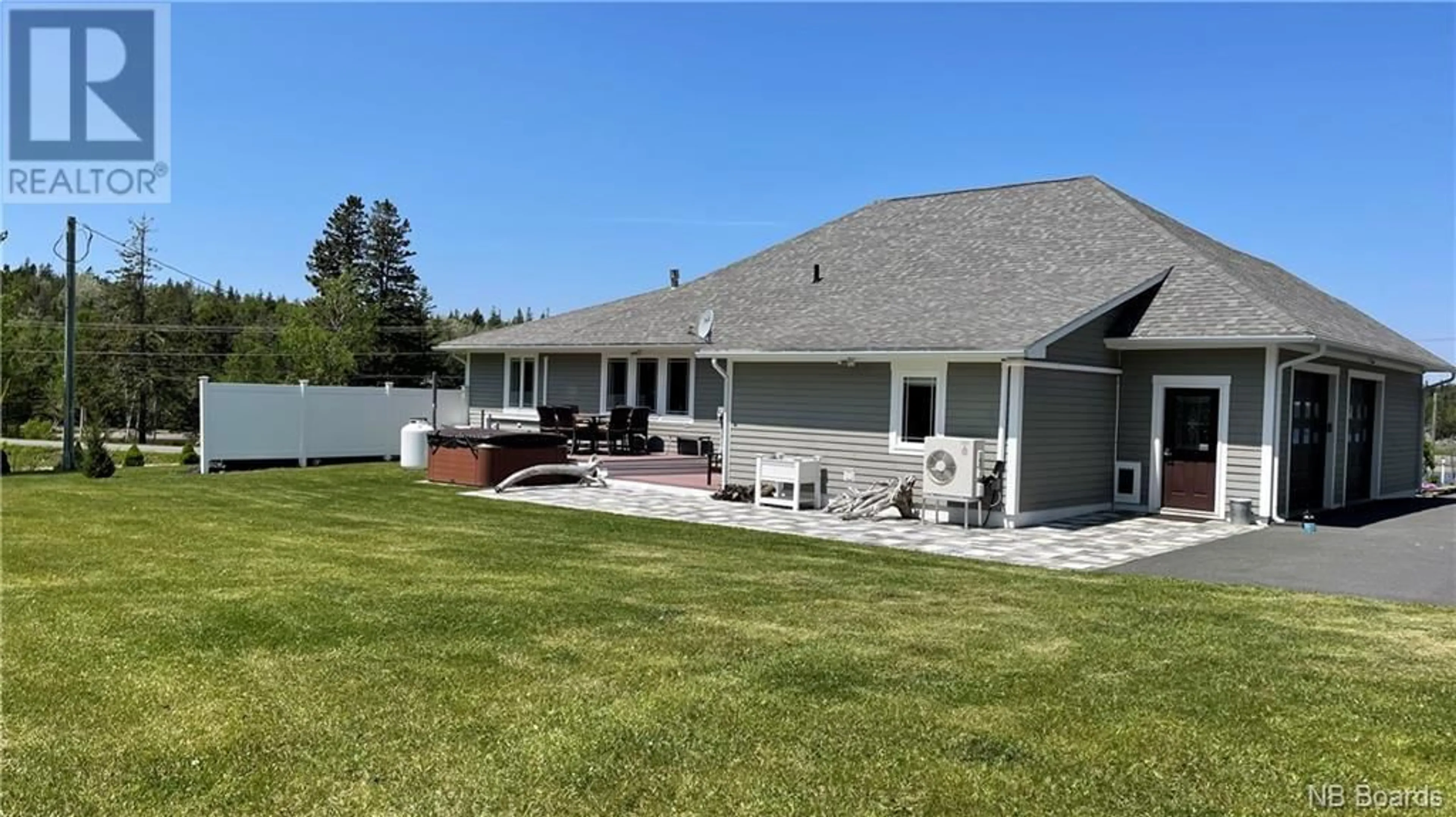 Frontside or backside of a home, the fenced backyard for 905 Fundy Drive, Campobello Island New Brunswick E5E1Y7