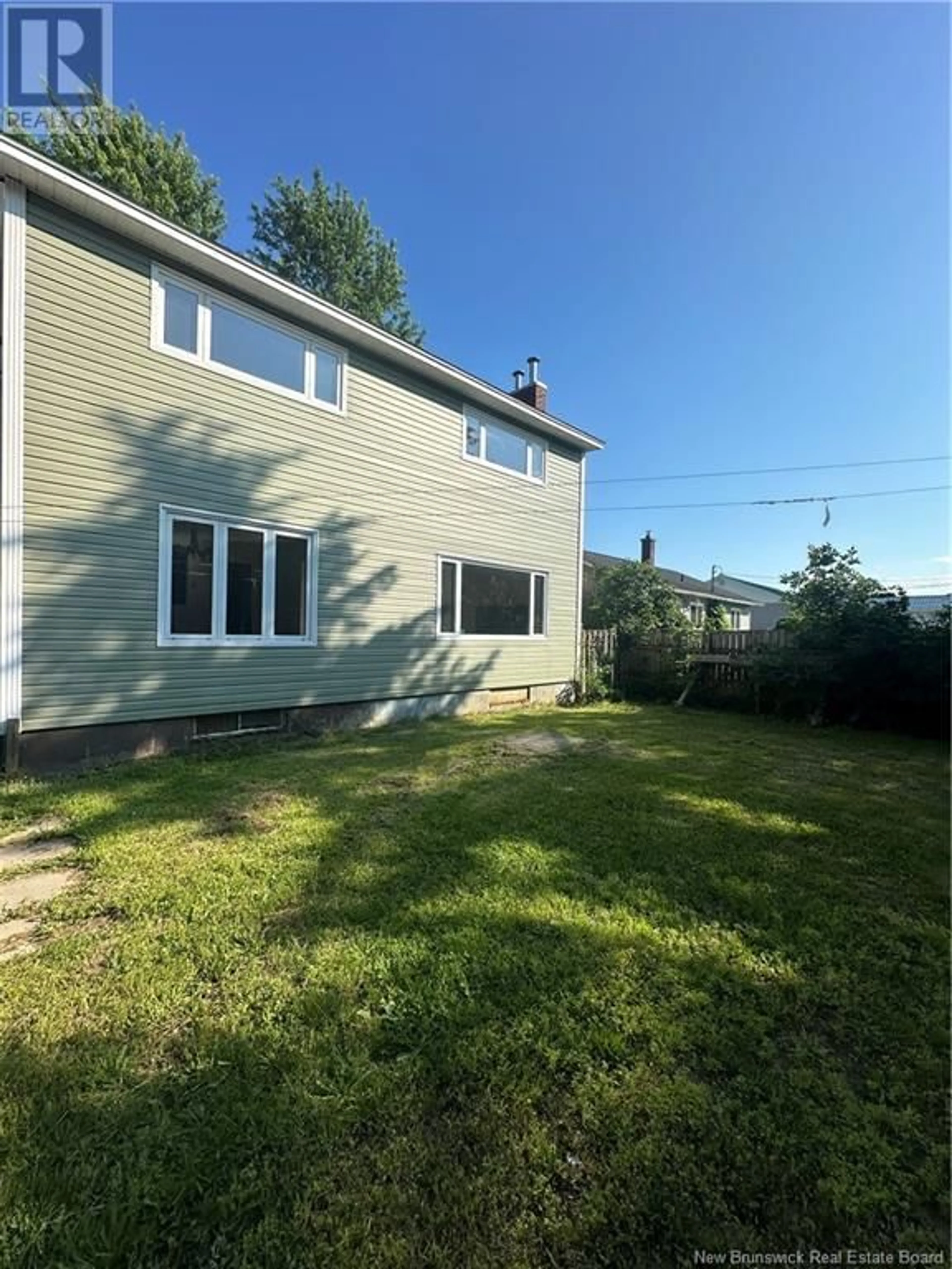 Frontside or backside of a home, the fenced backyard for 388 Skyline Avenue, Miramichi New Brunswick E1V1B2