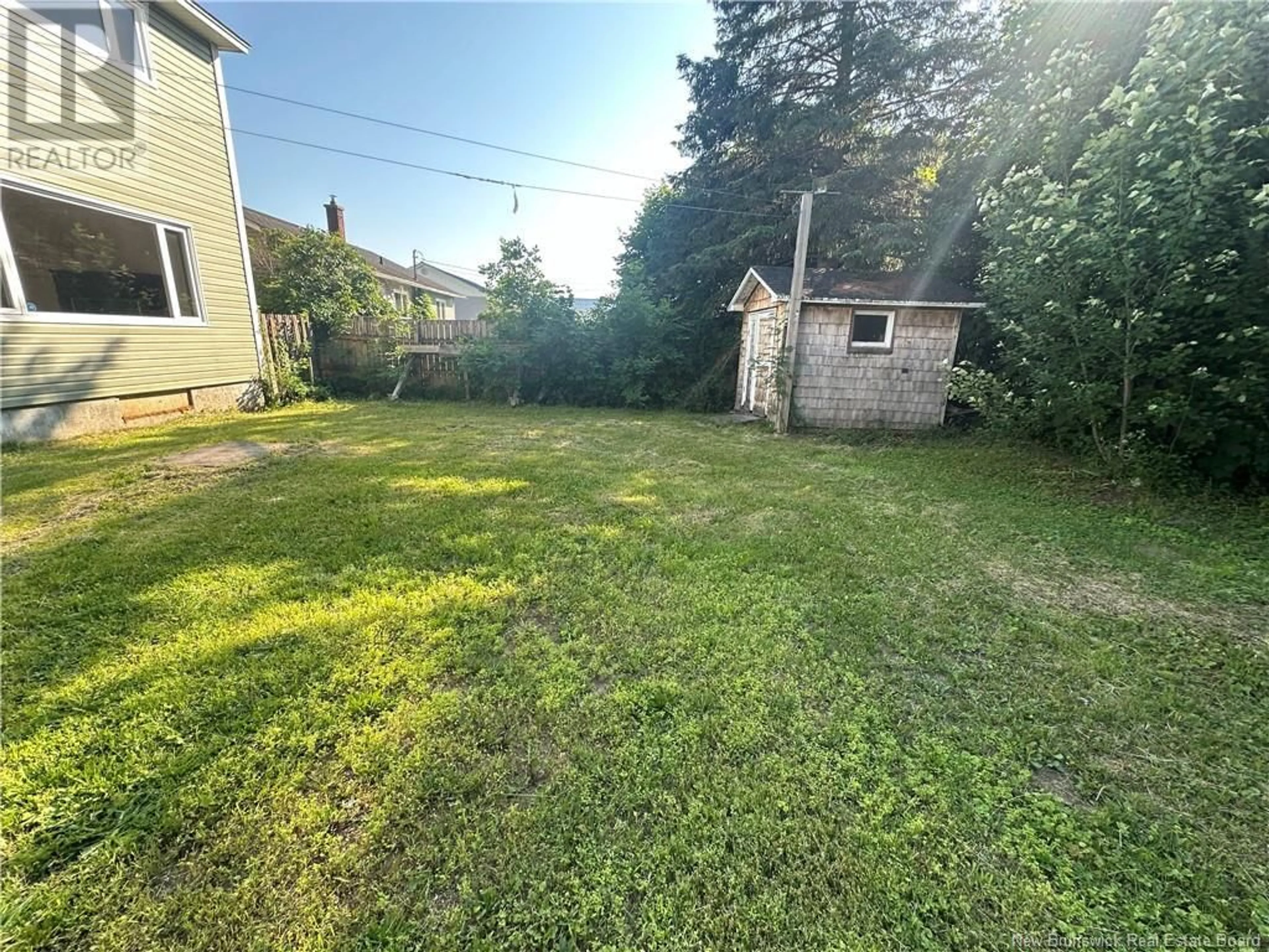 Frontside or backside of a home, the fenced backyard for 388 Skyline Avenue, Miramichi New Brunswick E1V1B2