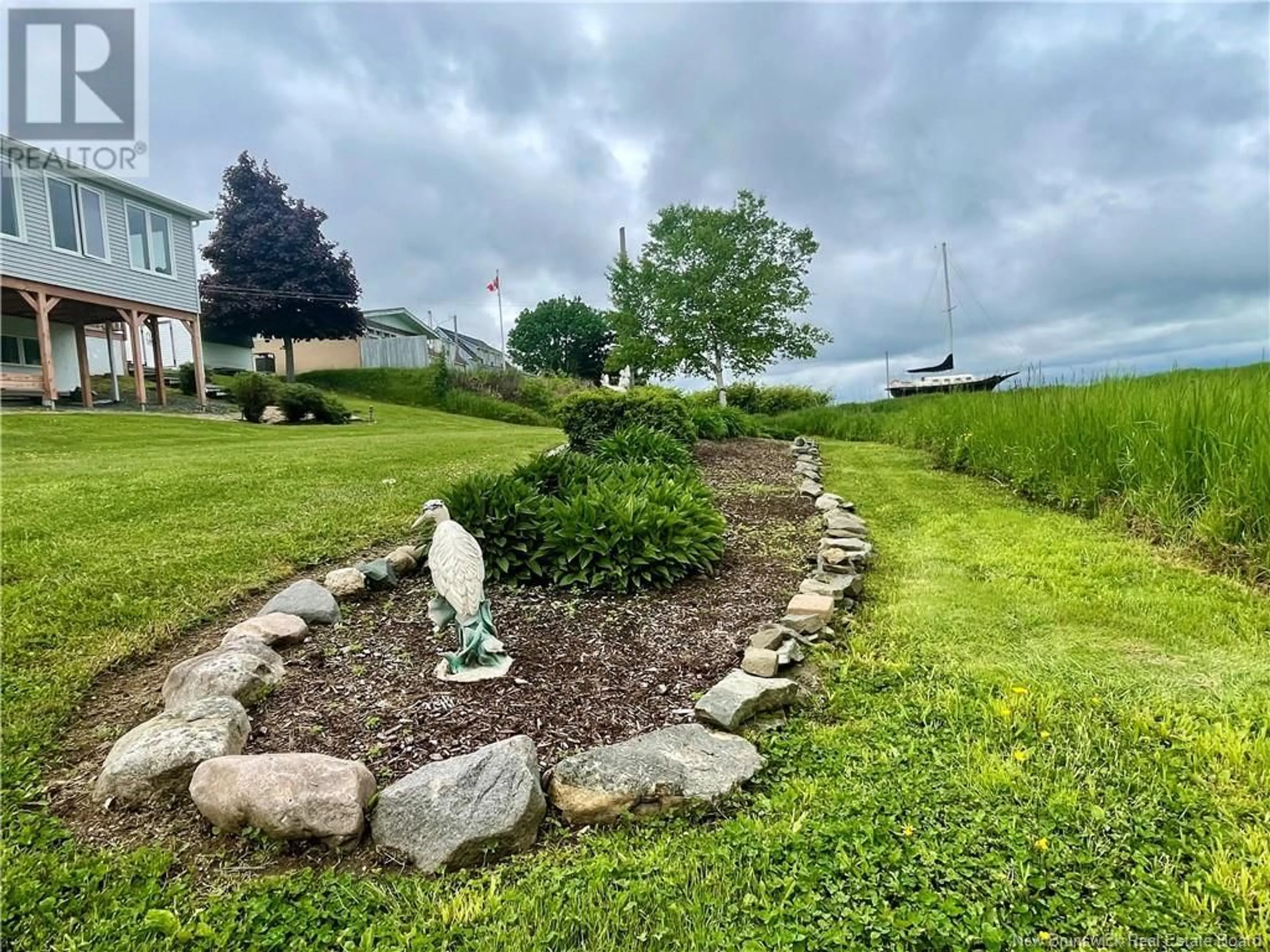 A pic from exterior of the house or condo, the fenced backyard for 4345 Water Street, Miramichi New Brunswick E1N4L9