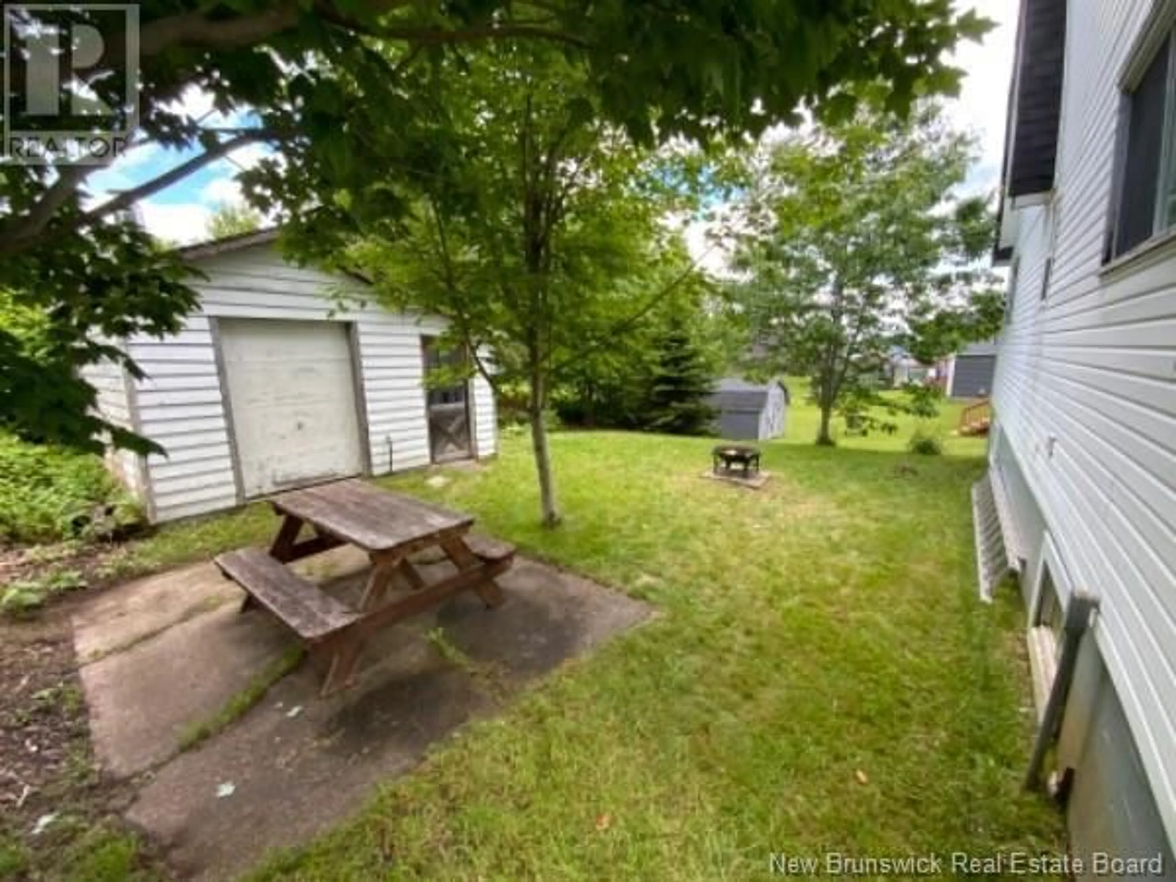 Patio, the fenced backyard for 48 Fundy View Drive, Alma New Brunswick E4H1H7