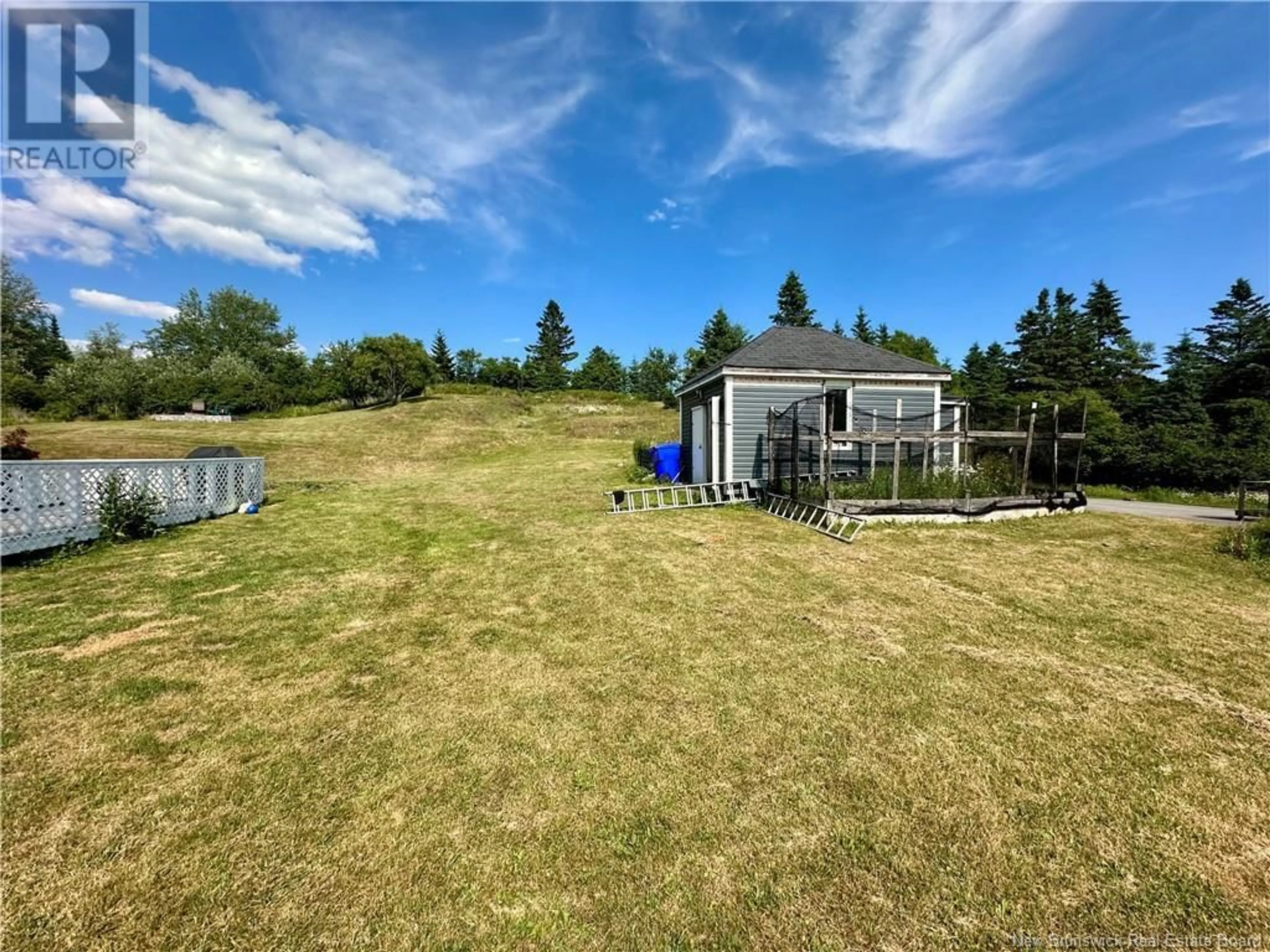 Frontside or backside of a home, the fenced backyard for 635 Main Street, Beaver Harbour New Brunswick E5H1N8