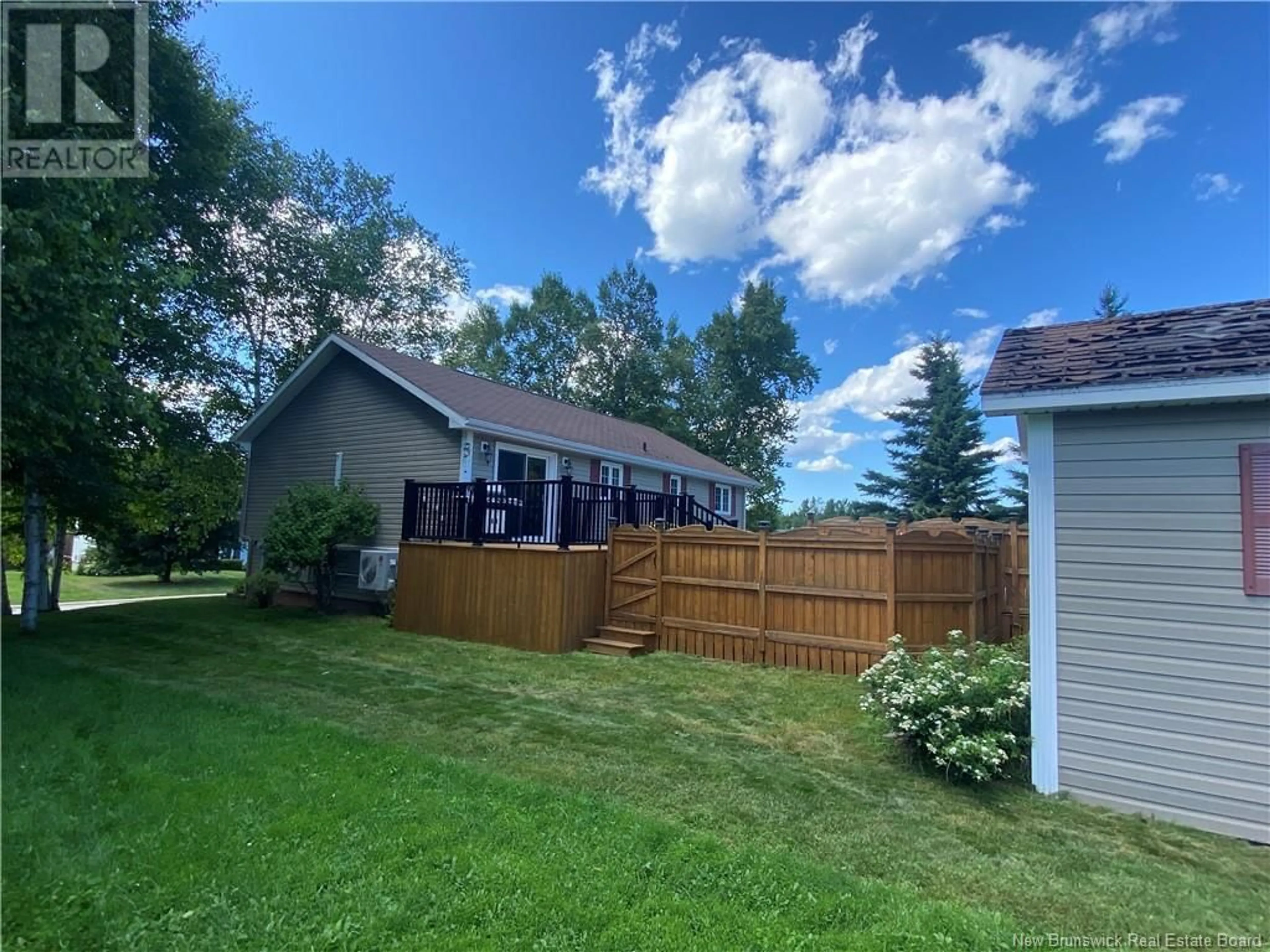 Frontside or backside of a home, the fenced backyard for 1060 Birchwood Drive, Bathurst New Brunswick E2A4W8