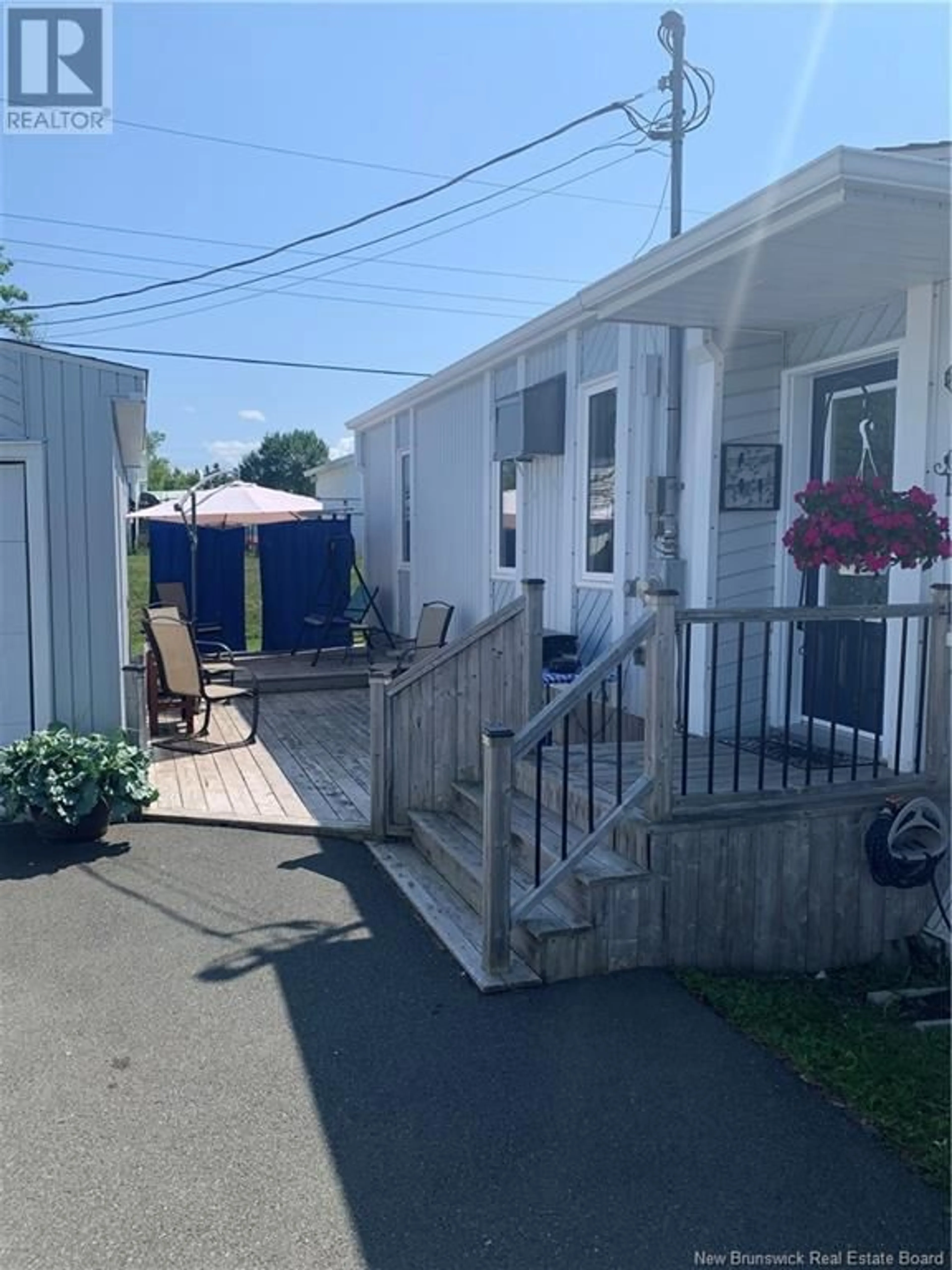 A pic from exterior of the house or condo, the fenced backyard for 6 2E AV DU PARC, Caraquet New Brunswick E1W1A7