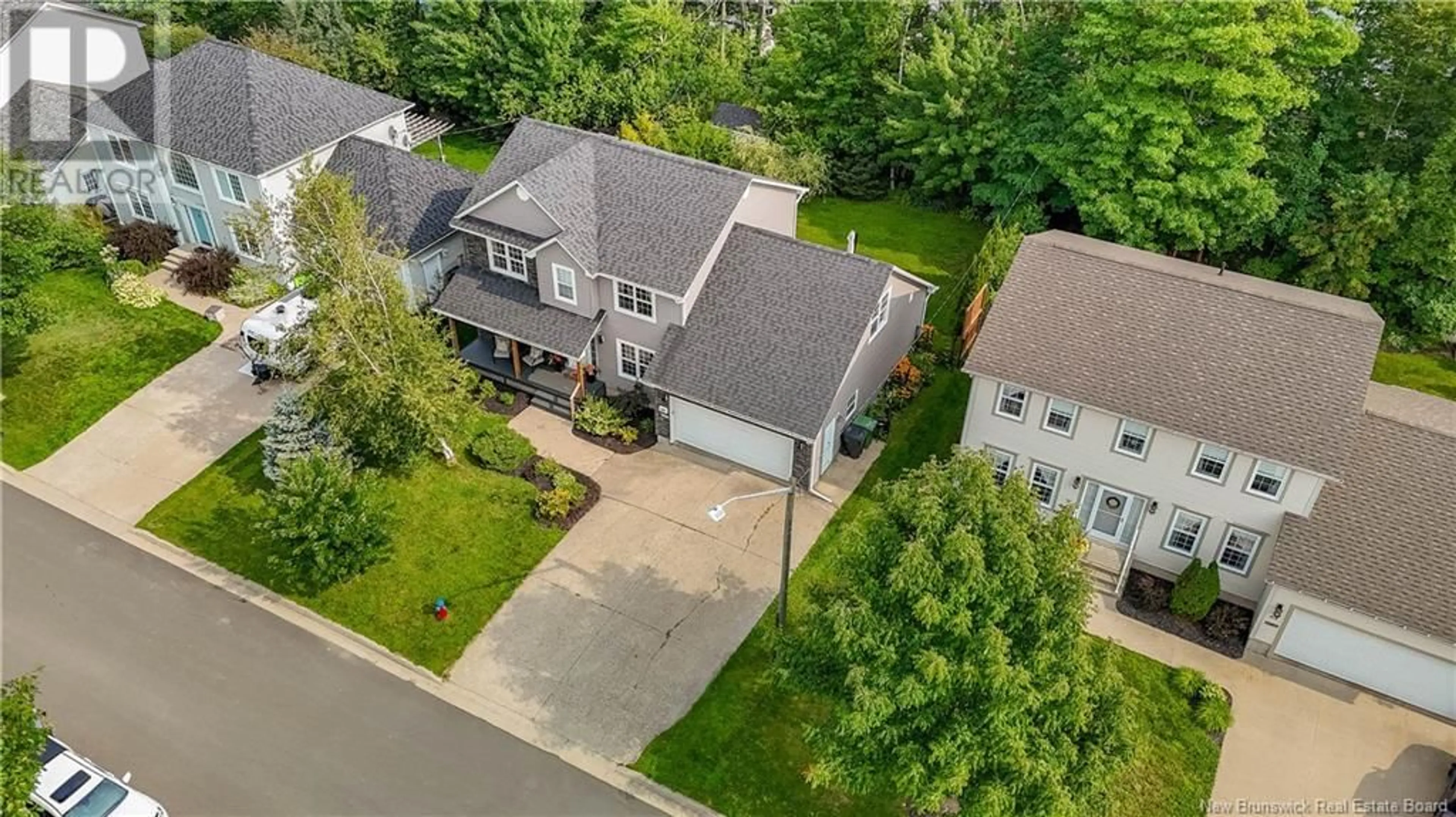 Frontside or backside of a home, the fenced backyard for 69 Bliss Carman Drive, Fredericton New Brunswick E3B9P2