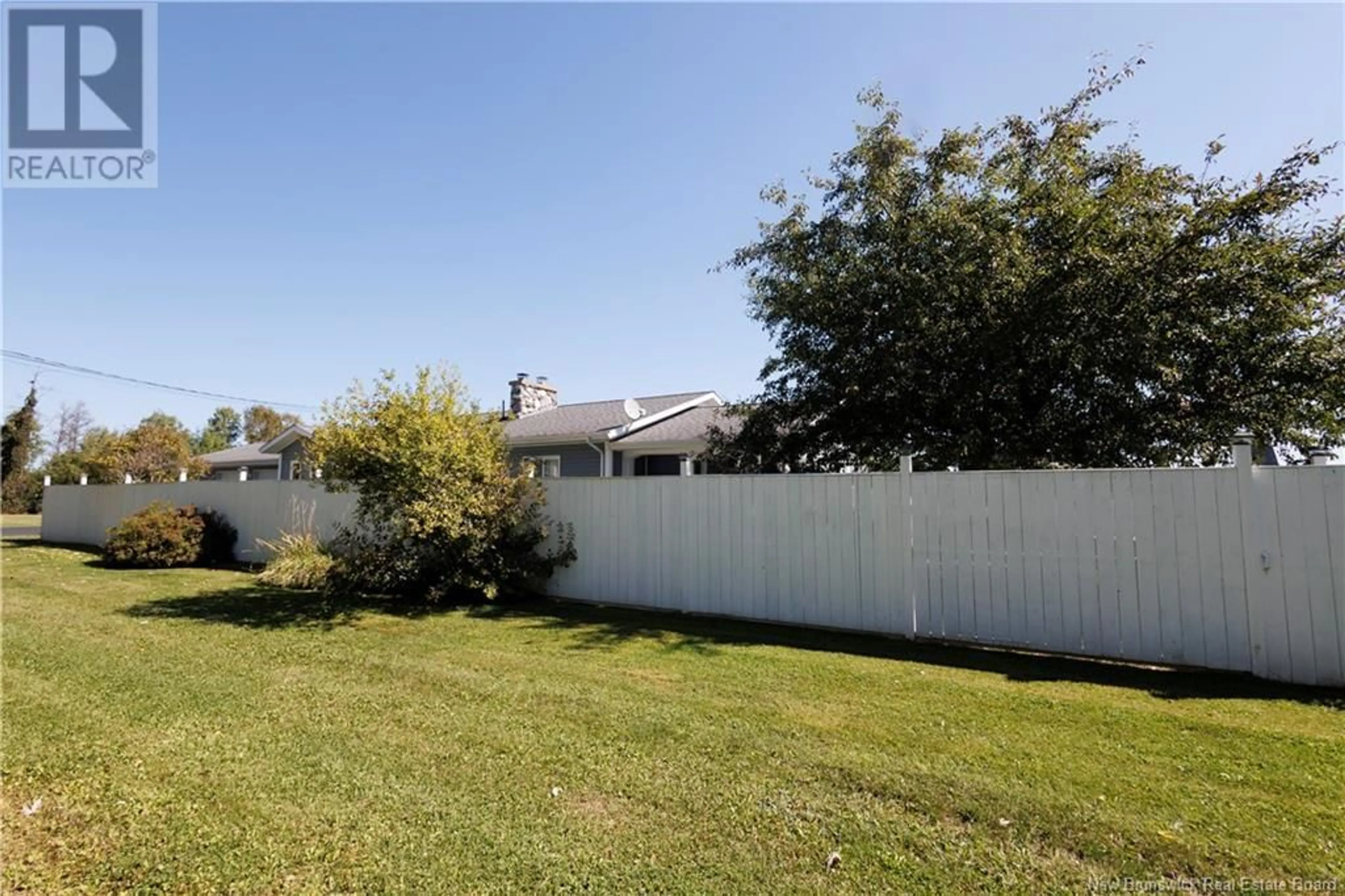 A pic from exterior of the house or condo, the fenced backyard for 26 First Street, Plaster Rock New Brunswick E7G1N4