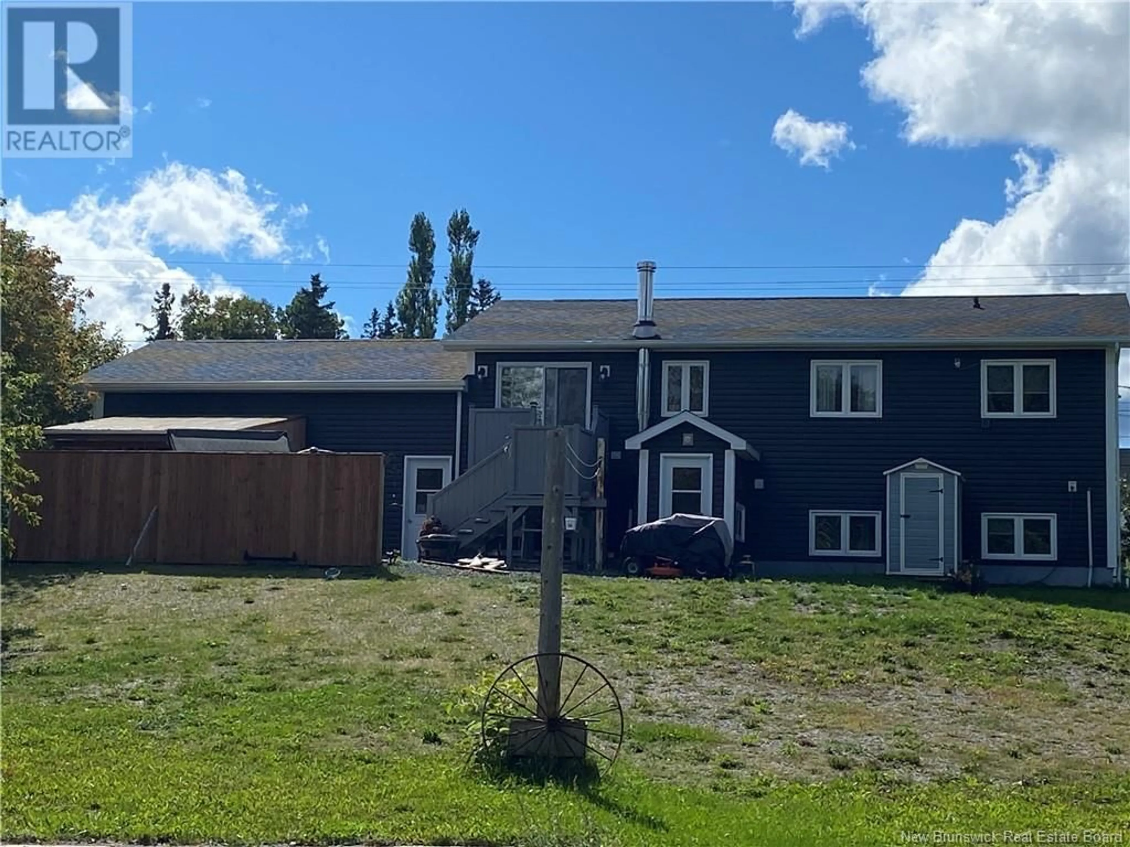 Frontside or backside of a home, the fenced backyard for 125 Rue Principale, Pointe-Verte New Brunswick E8J2V8