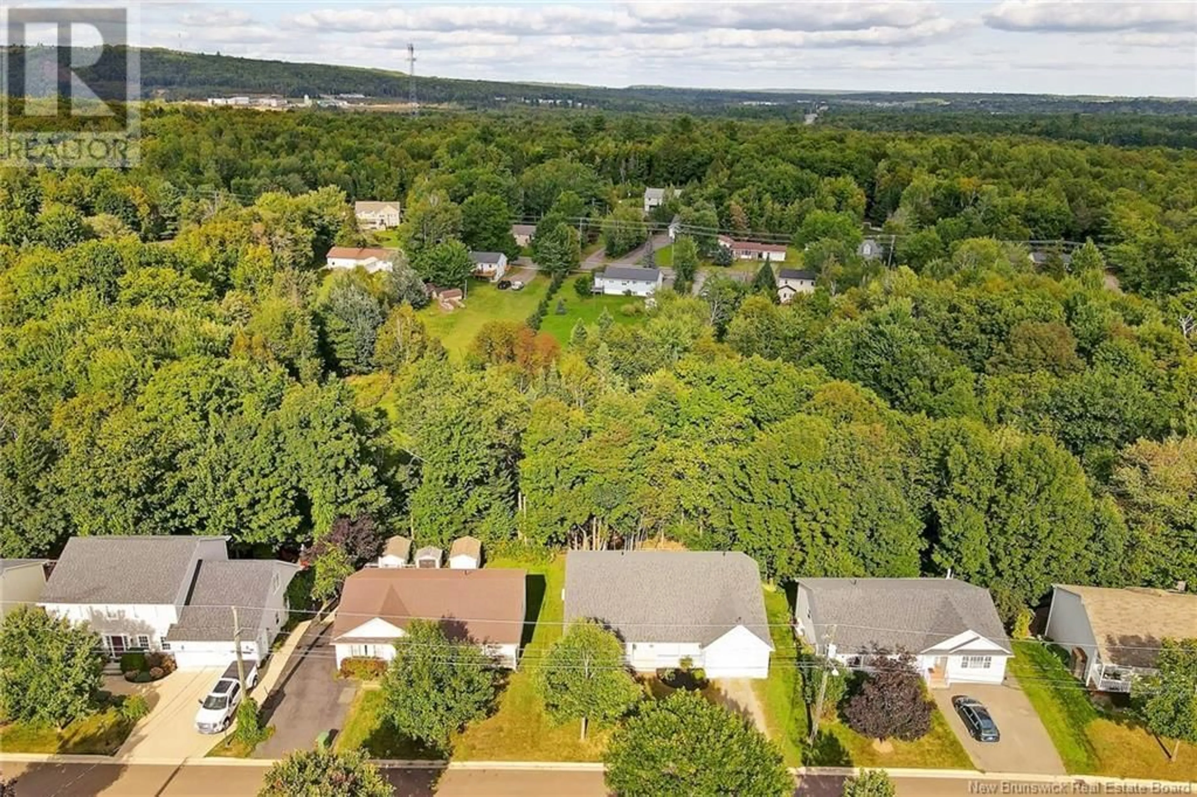 A pic from exterior of the house or condo, the fenced backyard for 52 MacLean Court, Fredericton New Brunswick E3G9Y1