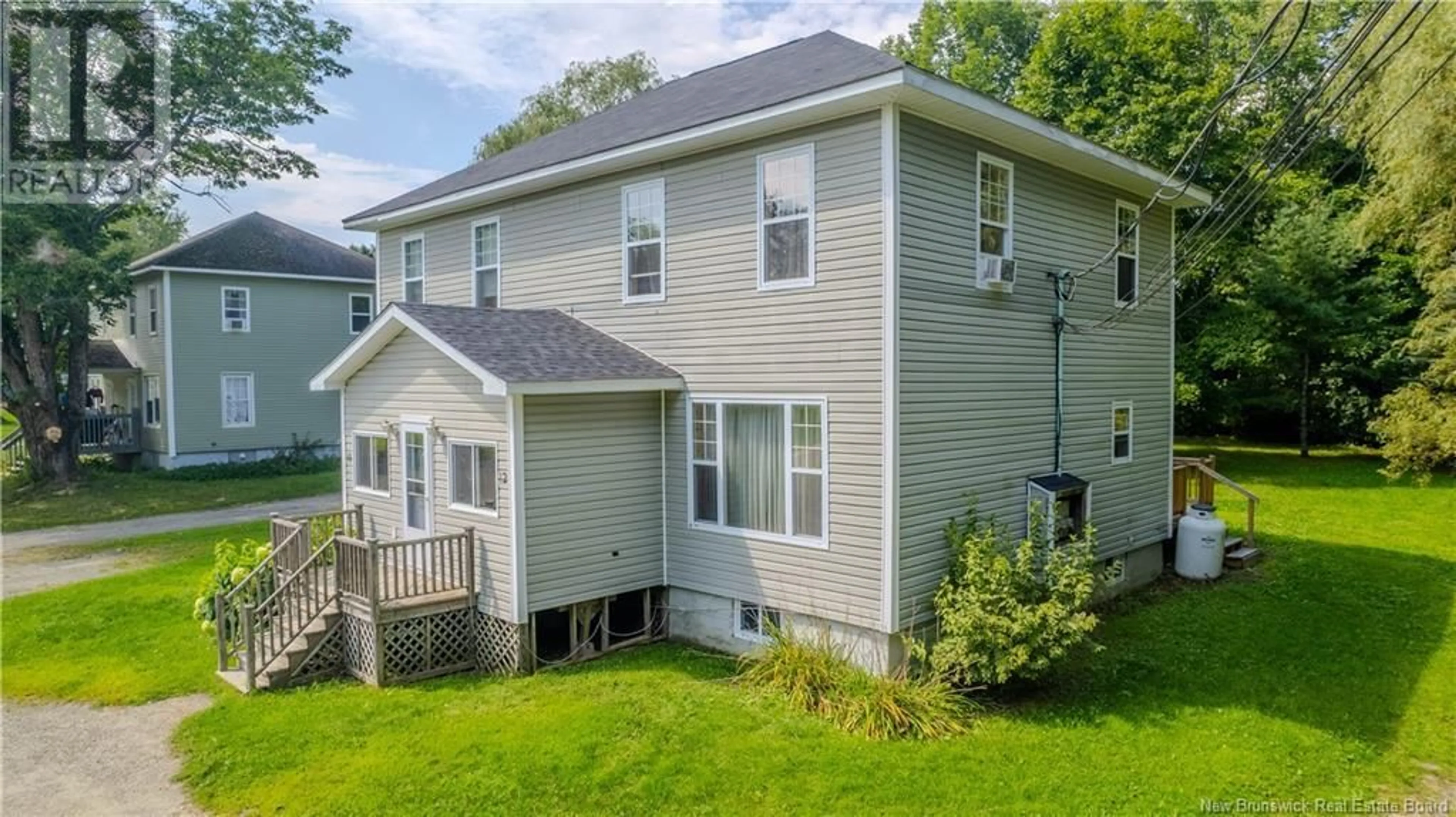 A pic from exterior of the house or condo, the fenced backyard for 10-12 St. James Street, St. Stephen New Brunswick E3L1N7