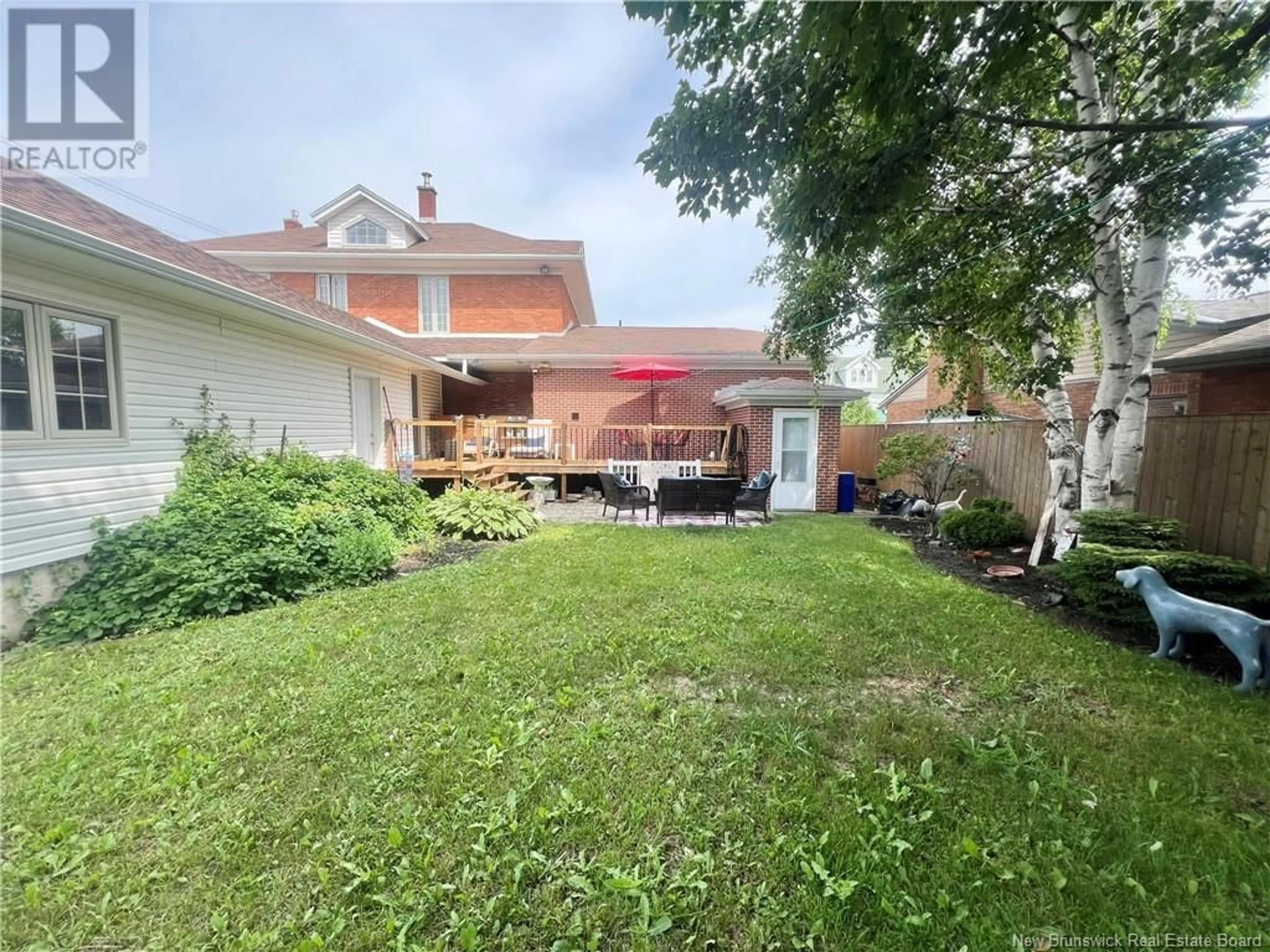 Frontside or backside of a home, the fenced backyard for 102 St. George Street, Bathurst New Brunswick E2A1B5