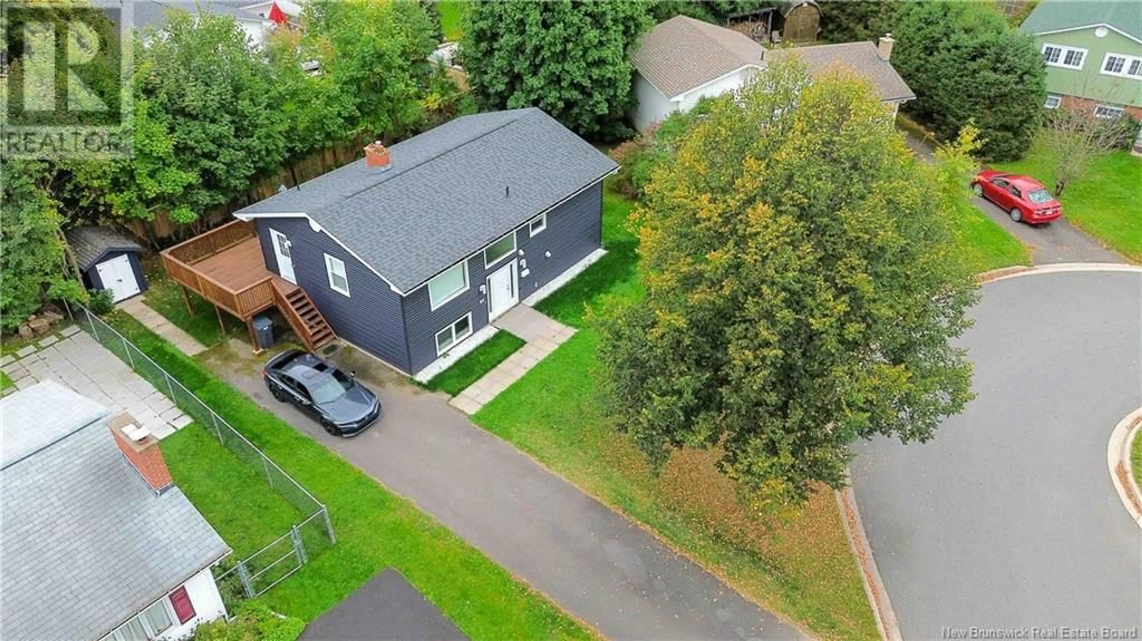 Frontside or backside of a home, the fenced backyard for 64 Parklyn Court, Fredericton New Brunswick E3B2T5