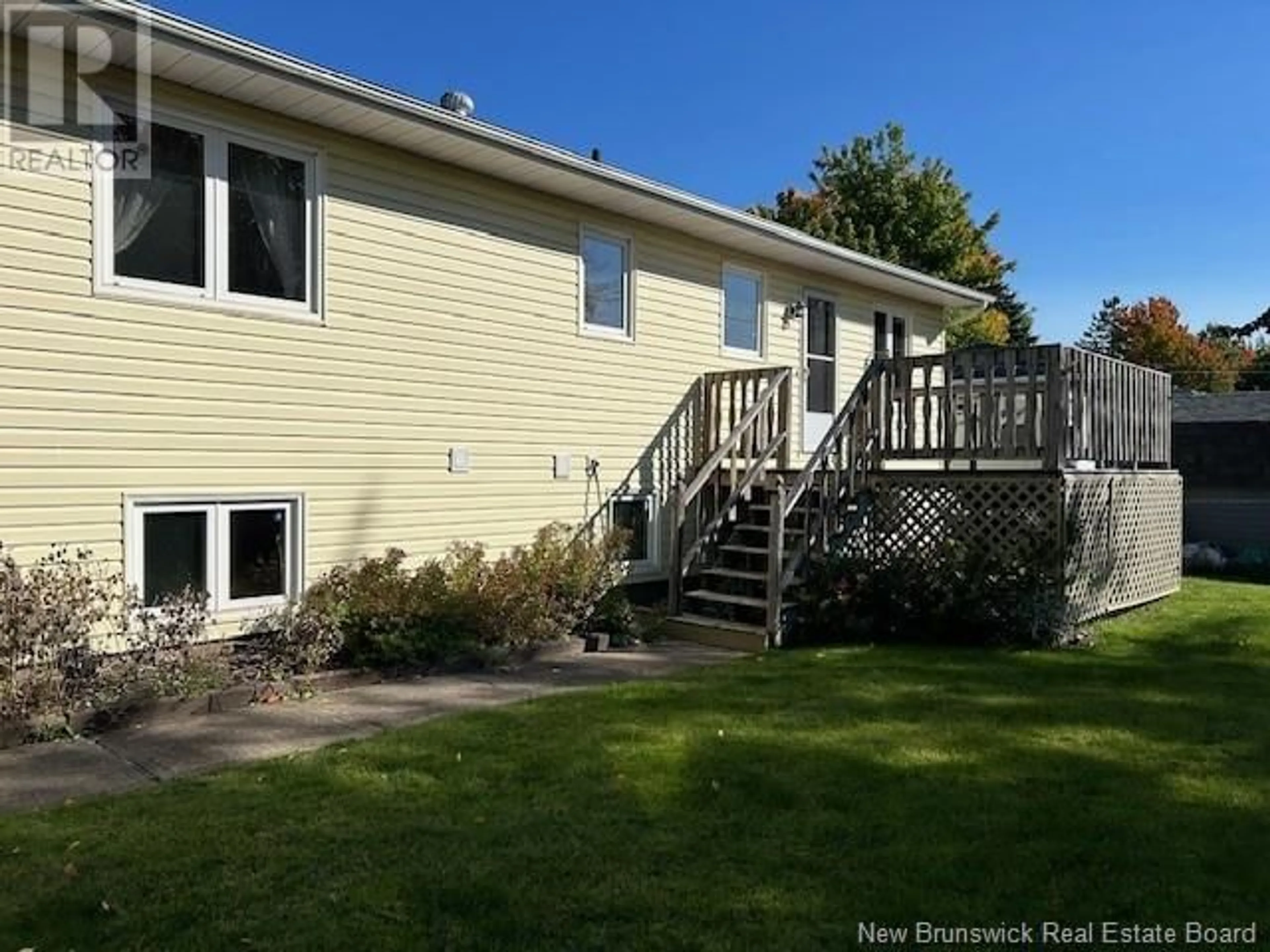 Frontside or backside of a home, the fenced backyard for 20 Woodleigh Street, Moncton New Brunswick E1C9A4