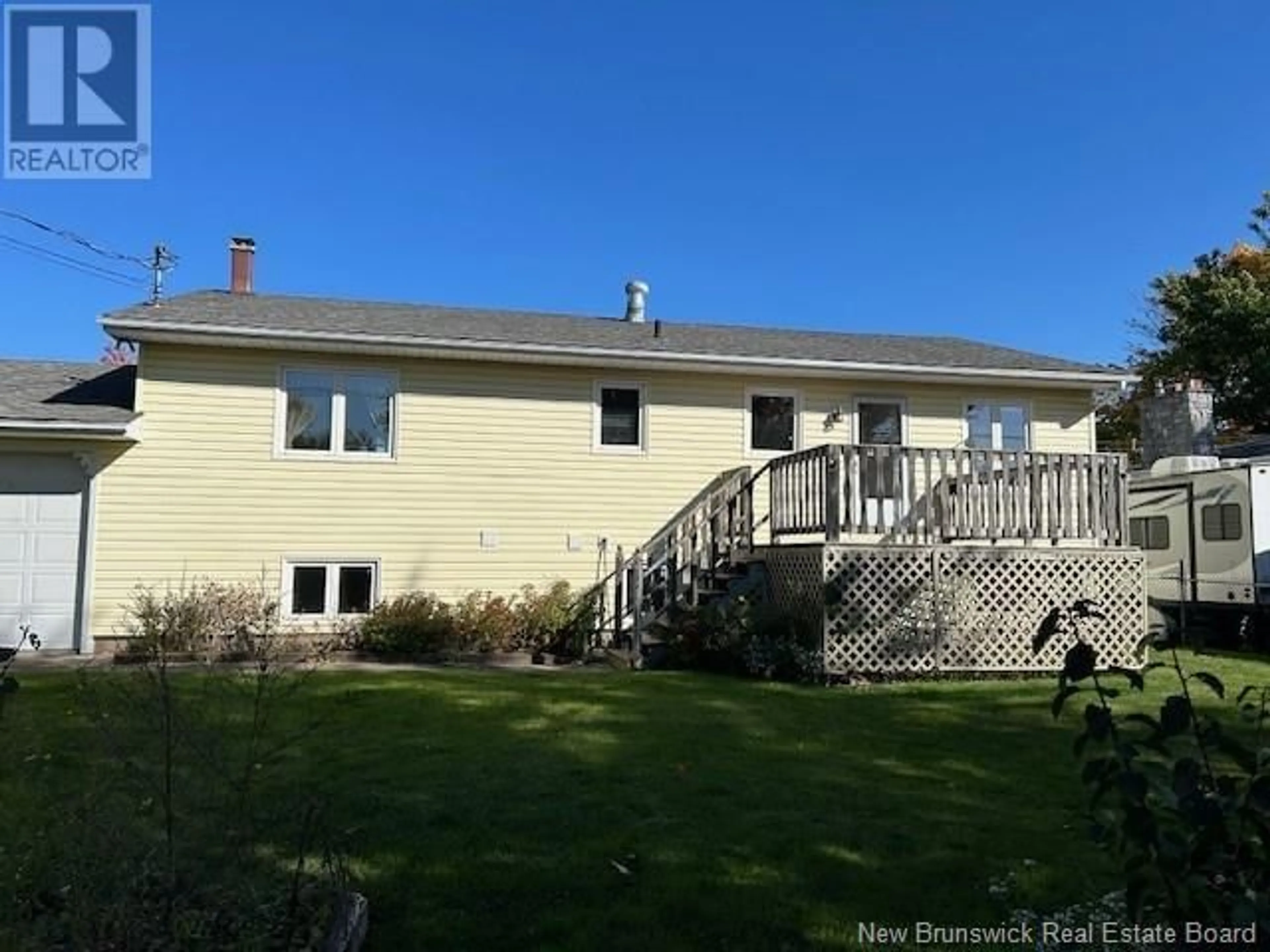 Frontside or backside of a home, the fenced backyard for 20 Woodleigh Street, Moncton New Brunswick E1C9A4