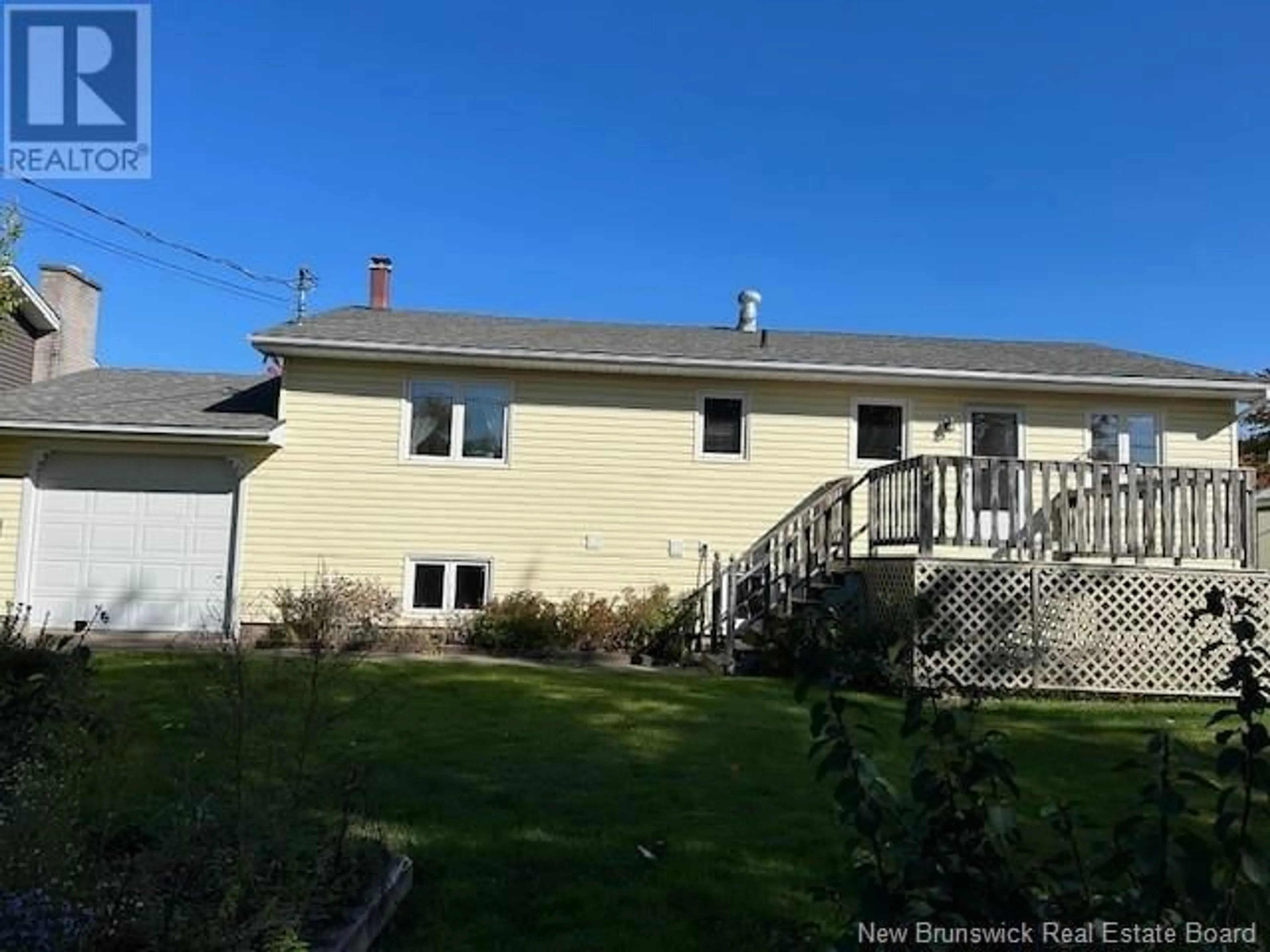 Frontside or backside of a home, the fenced backyard for 20 Woodleigh Street, Moncton New Brunswick E1C9A4