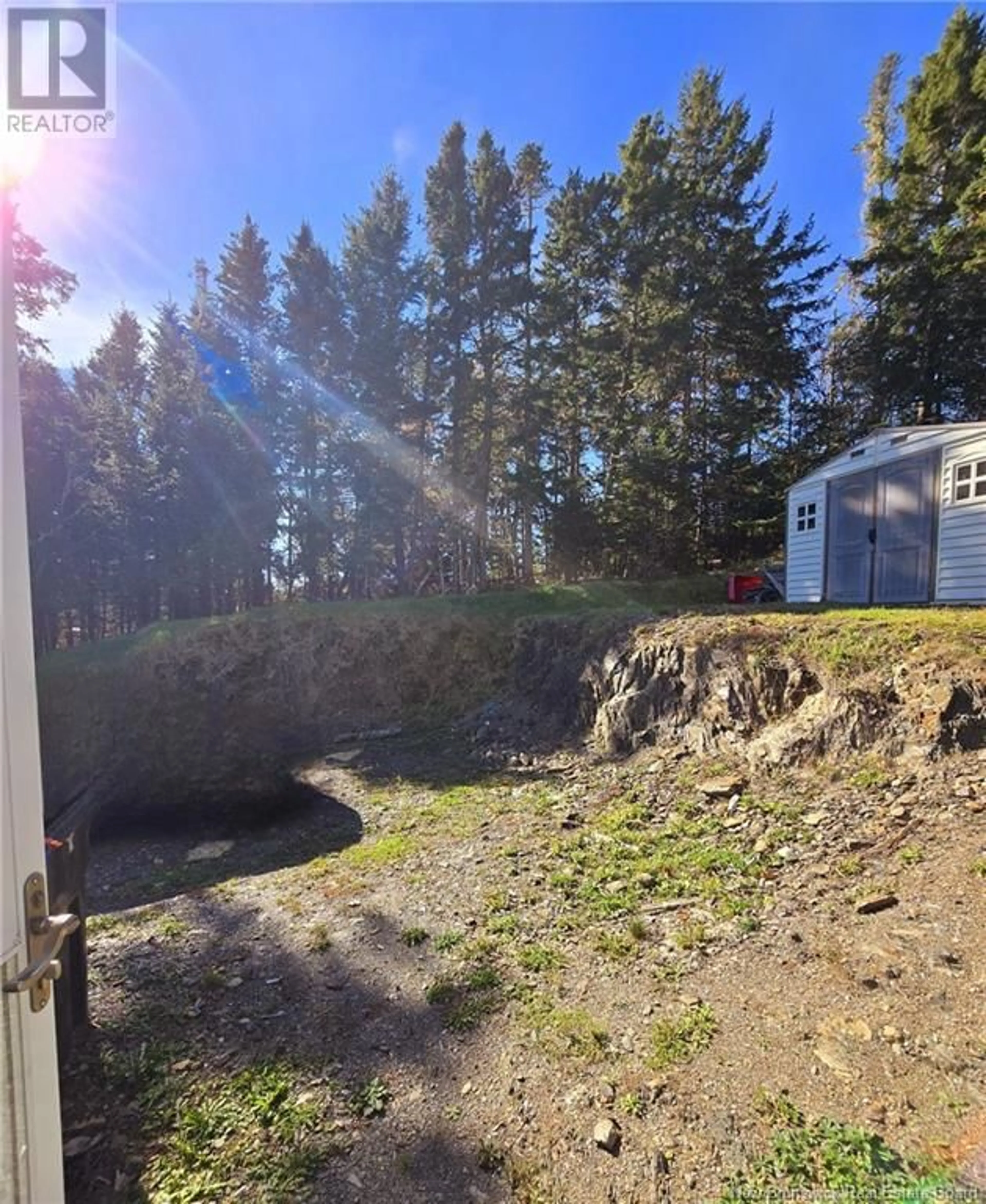 Frontside or backside of a home, the fenced backyard for 20 Beach, Beaver Harbour New Brunswick E5H1M5